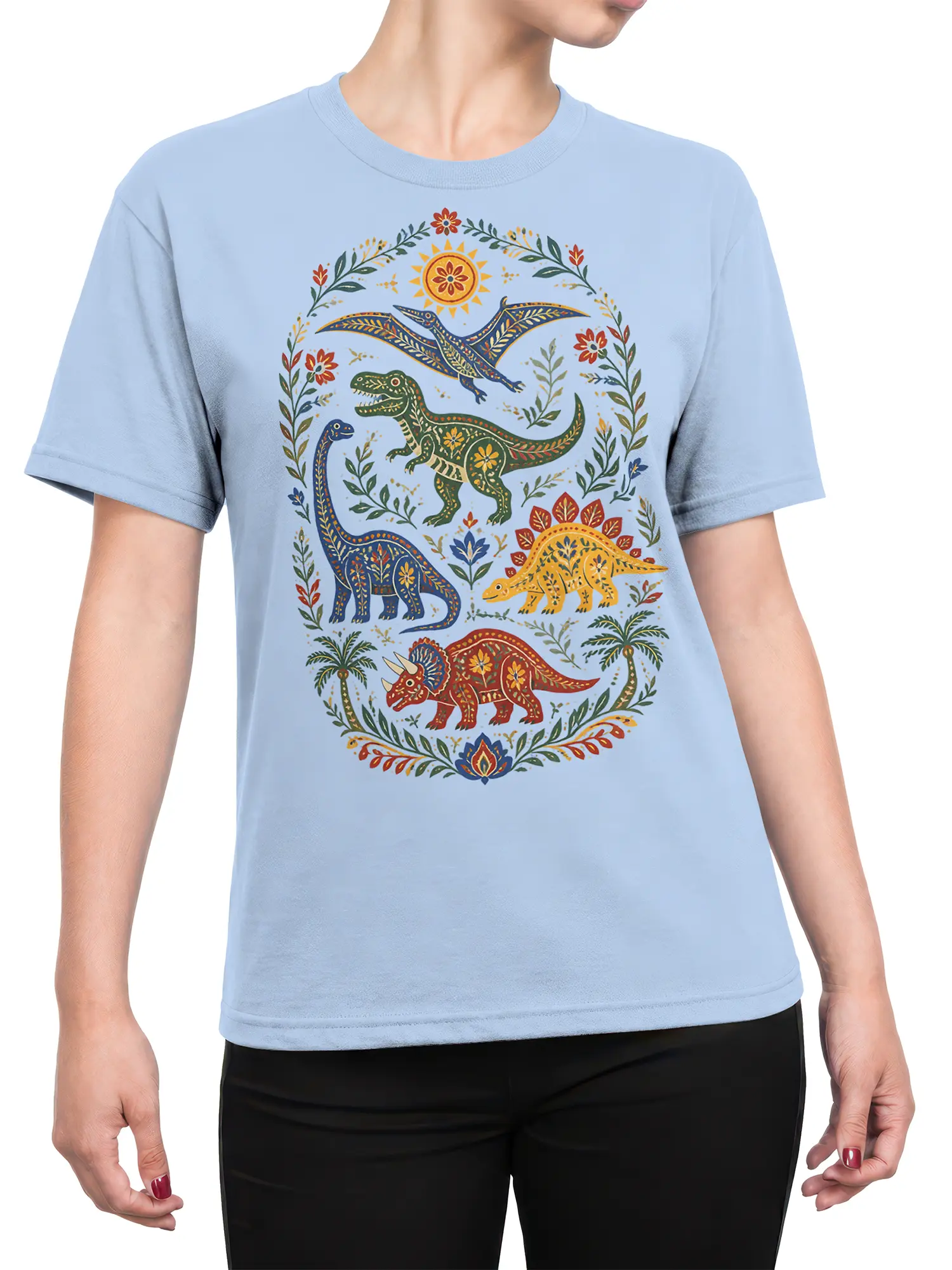 Female torso wearing a light blue dinosaur T-shirt with colorful prehistoric creatures and floral folk-art details