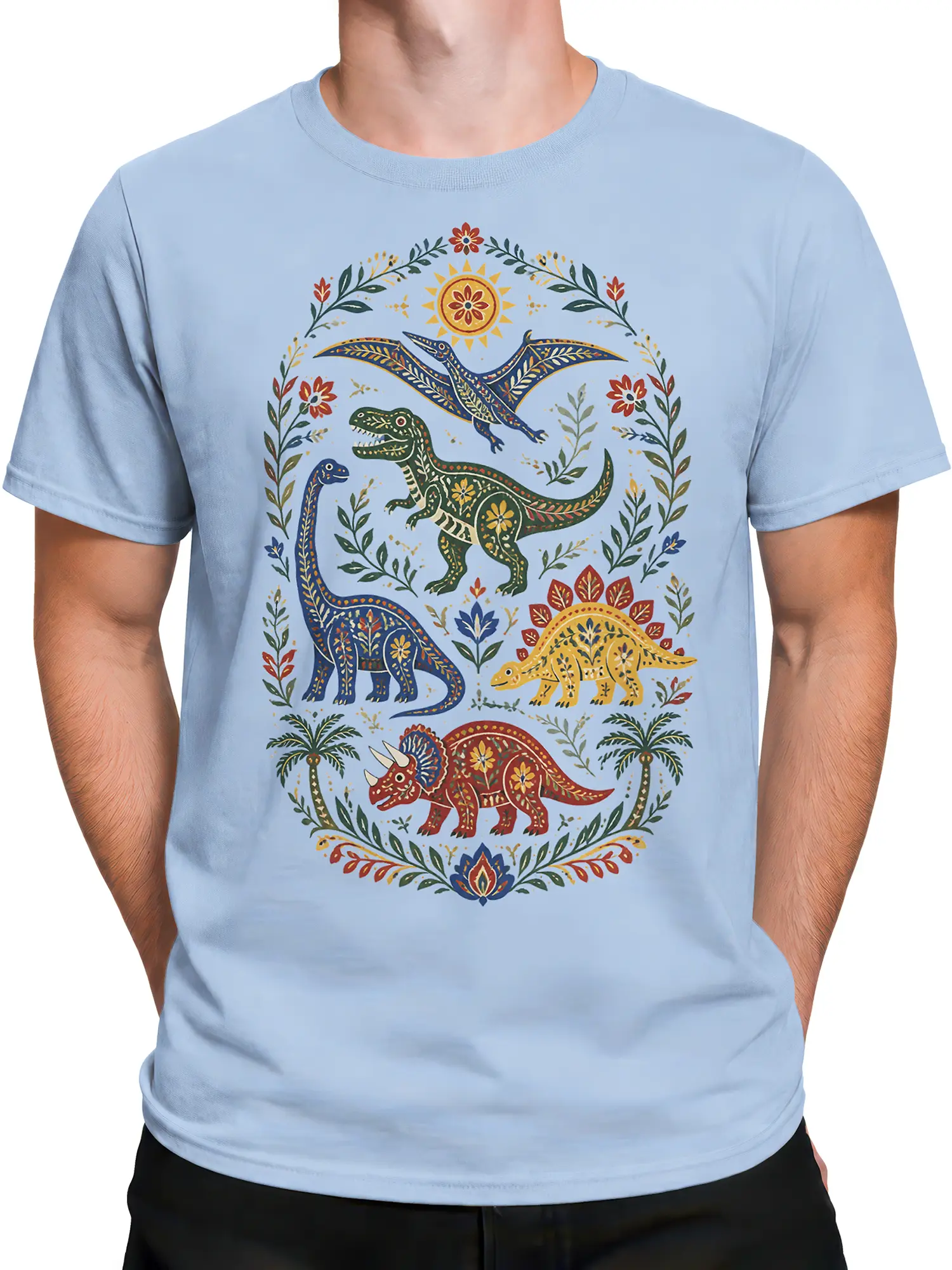 Male torso wearing a light blue dinosaur T-shirt with a colorful floral folk-art prehistoric scene