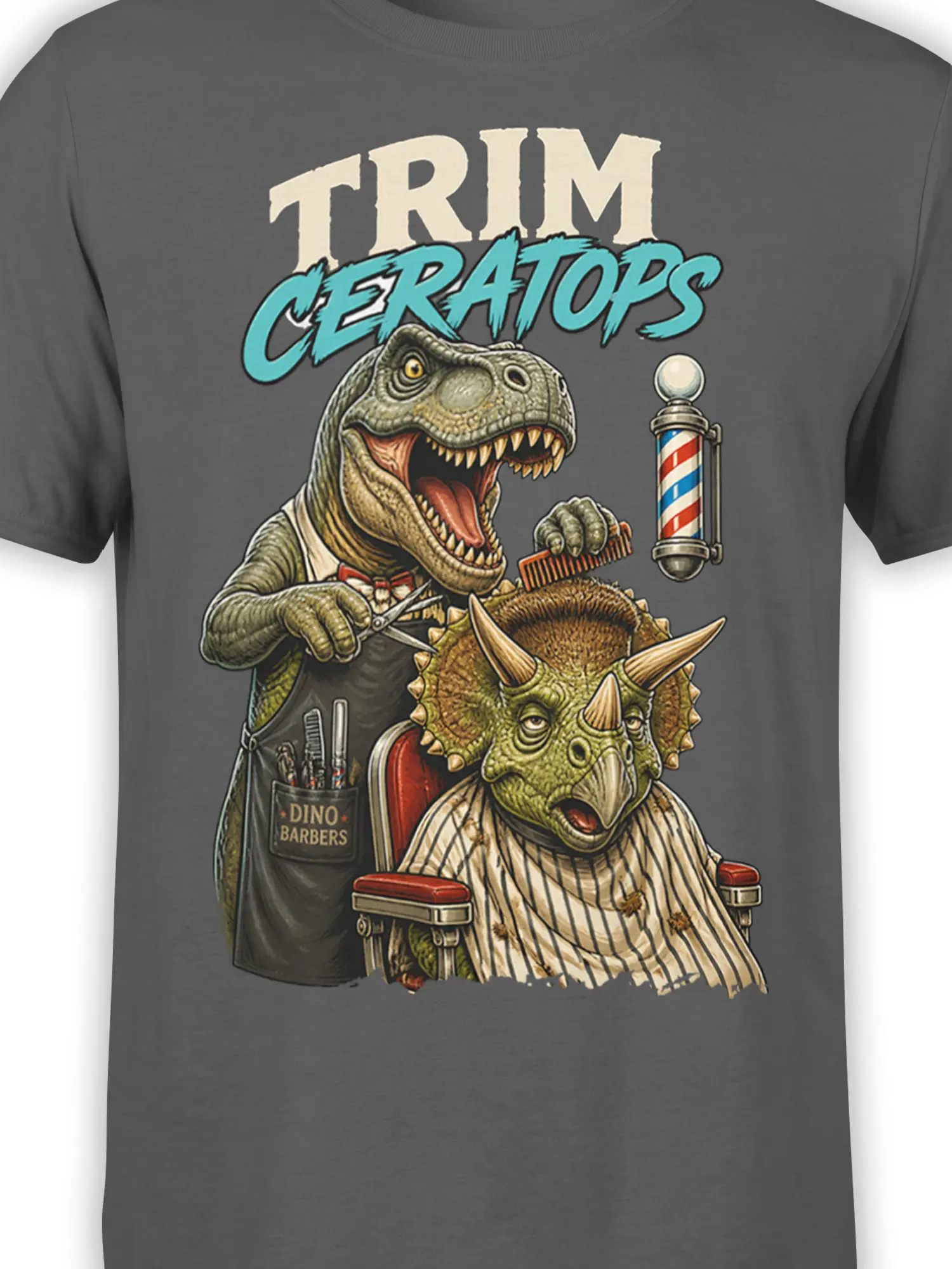 Close-up of dinosaur barber artwork with T-Rex, triceratops, scissors, comb, and barber pole on gray fabric