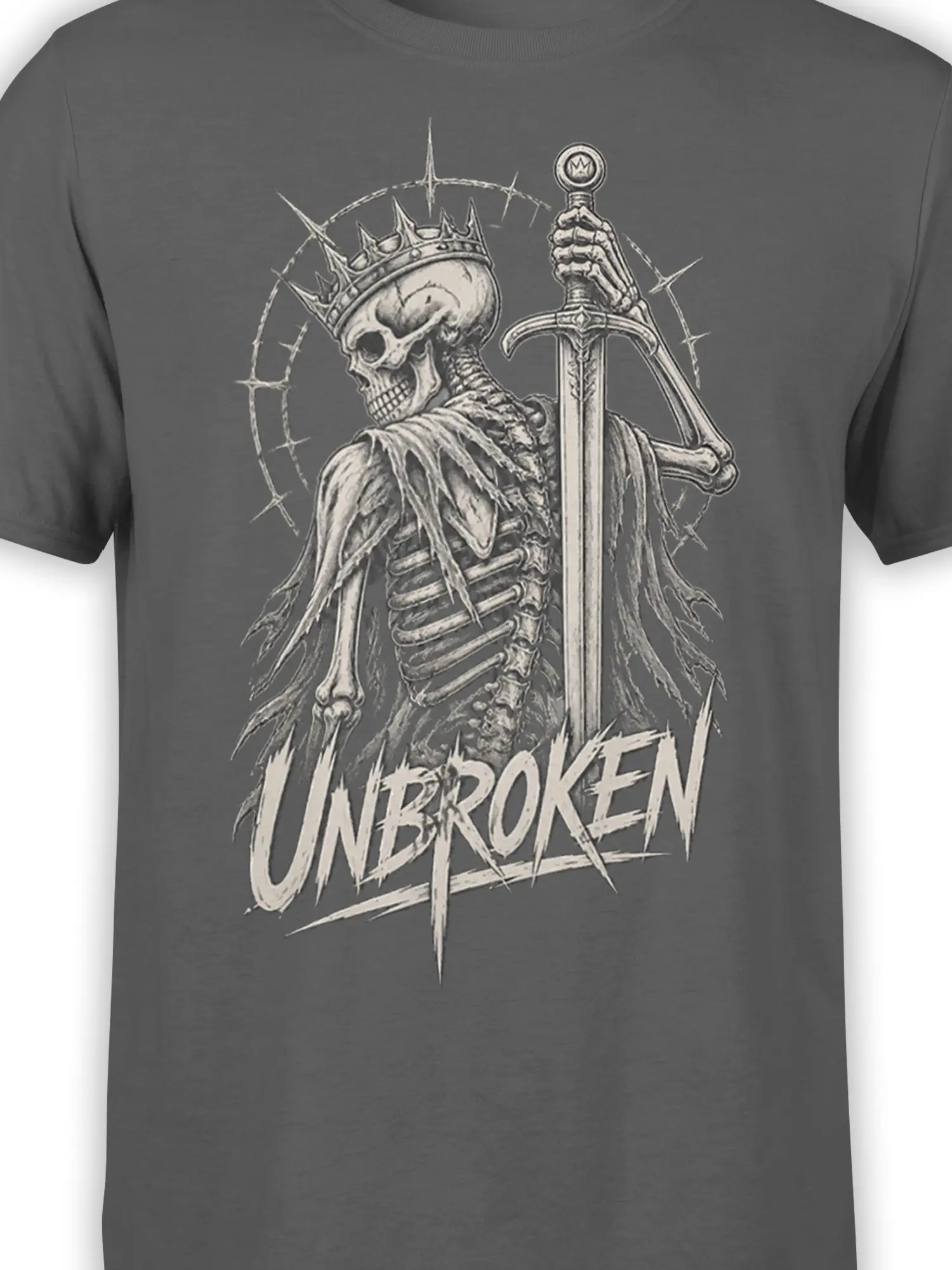 Close-up of crowned skeleton sword artwork and UNBROKEN text on a gray graphic tee