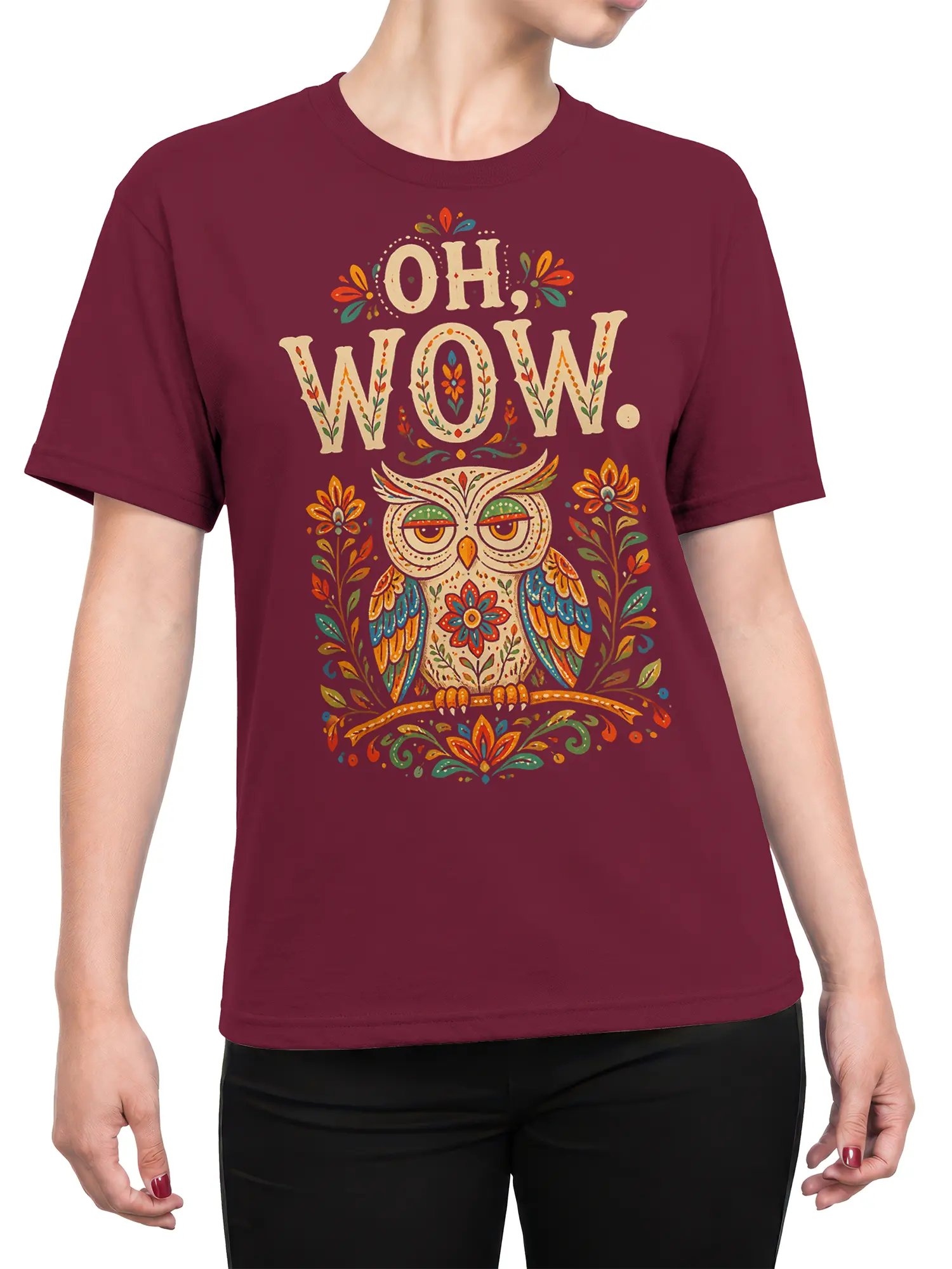 Female torso wearing a burgundy owl T-shirt with folk-floral artwork and colorful decorative details