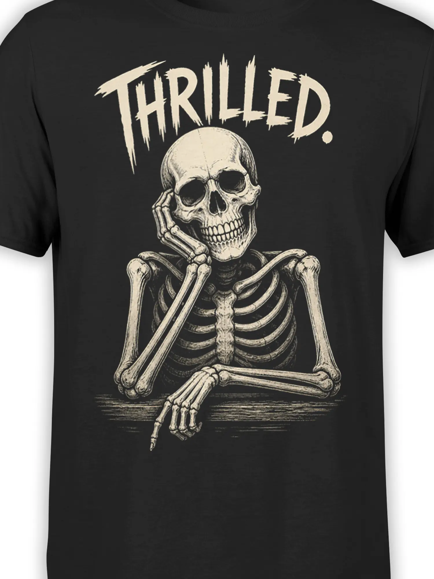 Close-up of the grinning skeleton artwork and distressed “THRILLED.” text on a black T-shirt