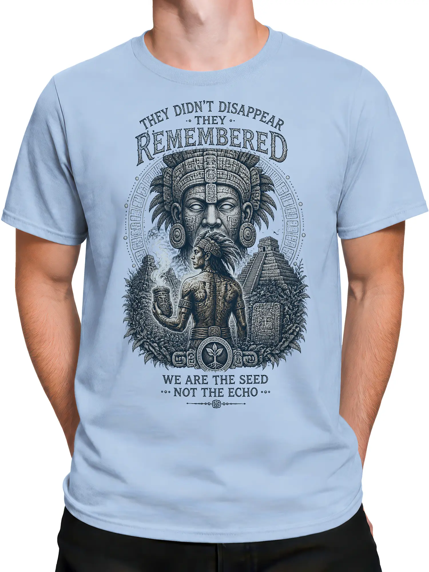Male torso wearing a light blue T-shirt with indigenous warrior and temple artwork