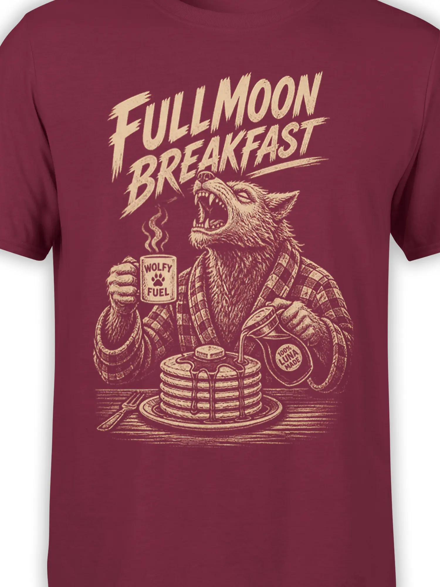 Close-up of the howling wolf breakfast design on a burgundy T-shirt with pancakes and moon-themed details