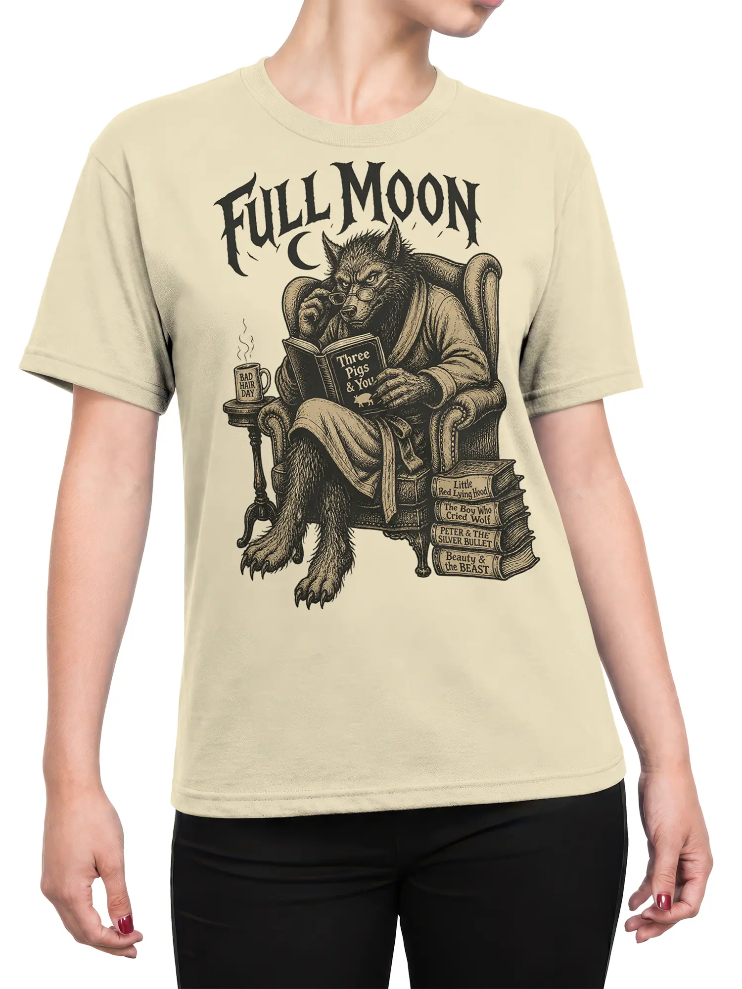 Female torso wearing a beige wolf reading T-shirt with full moon text and detailed vintage book artwork
