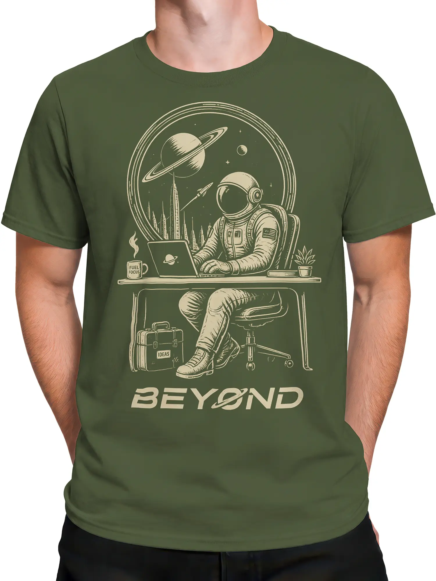Male torso wearing an olive green astronaut T-shirt with planets, desk artwork, and BEYOND text