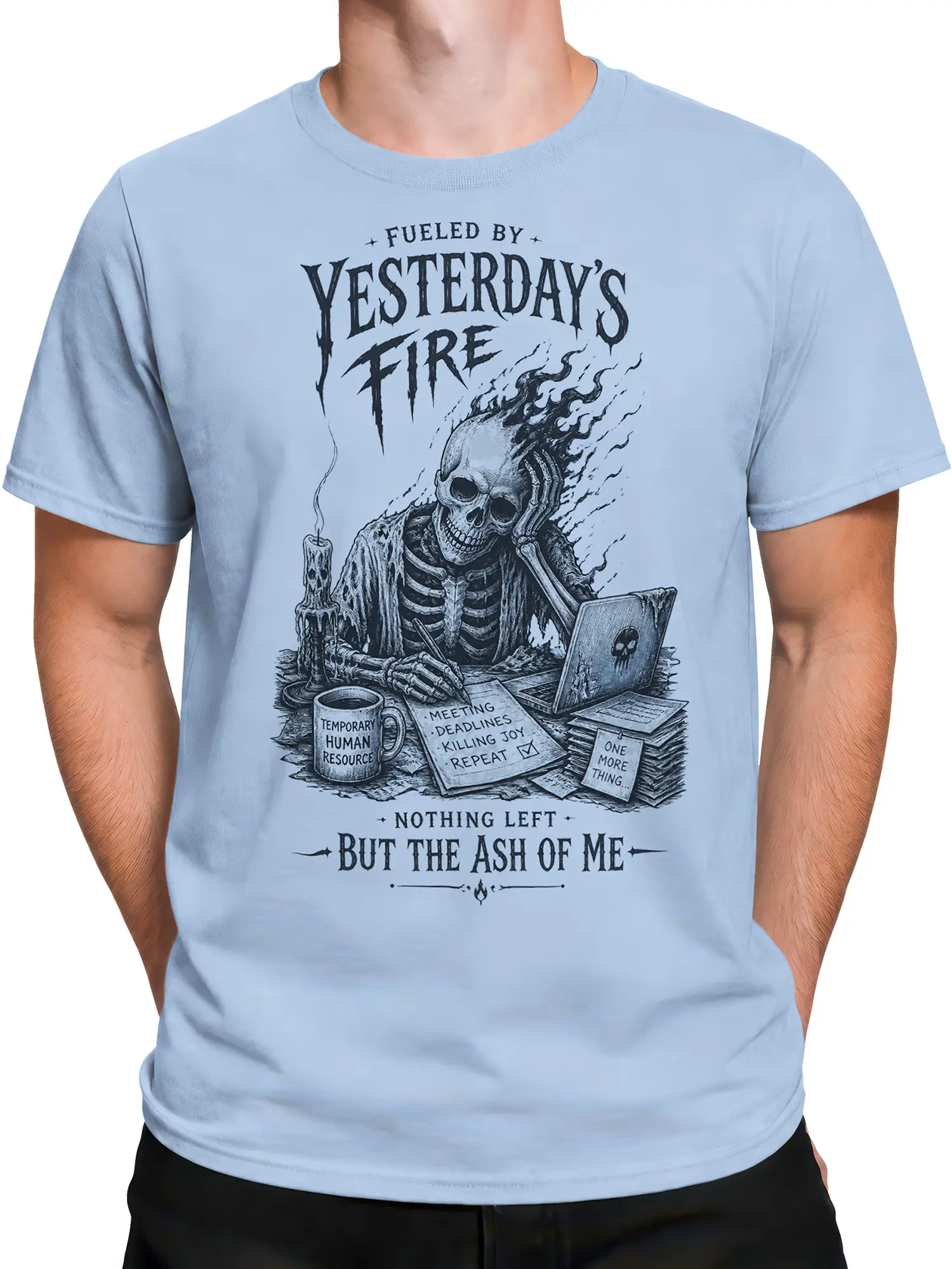 Male torso wearing a light blue skull office humor T-shirt with skeleton desk scene and burnout lettering