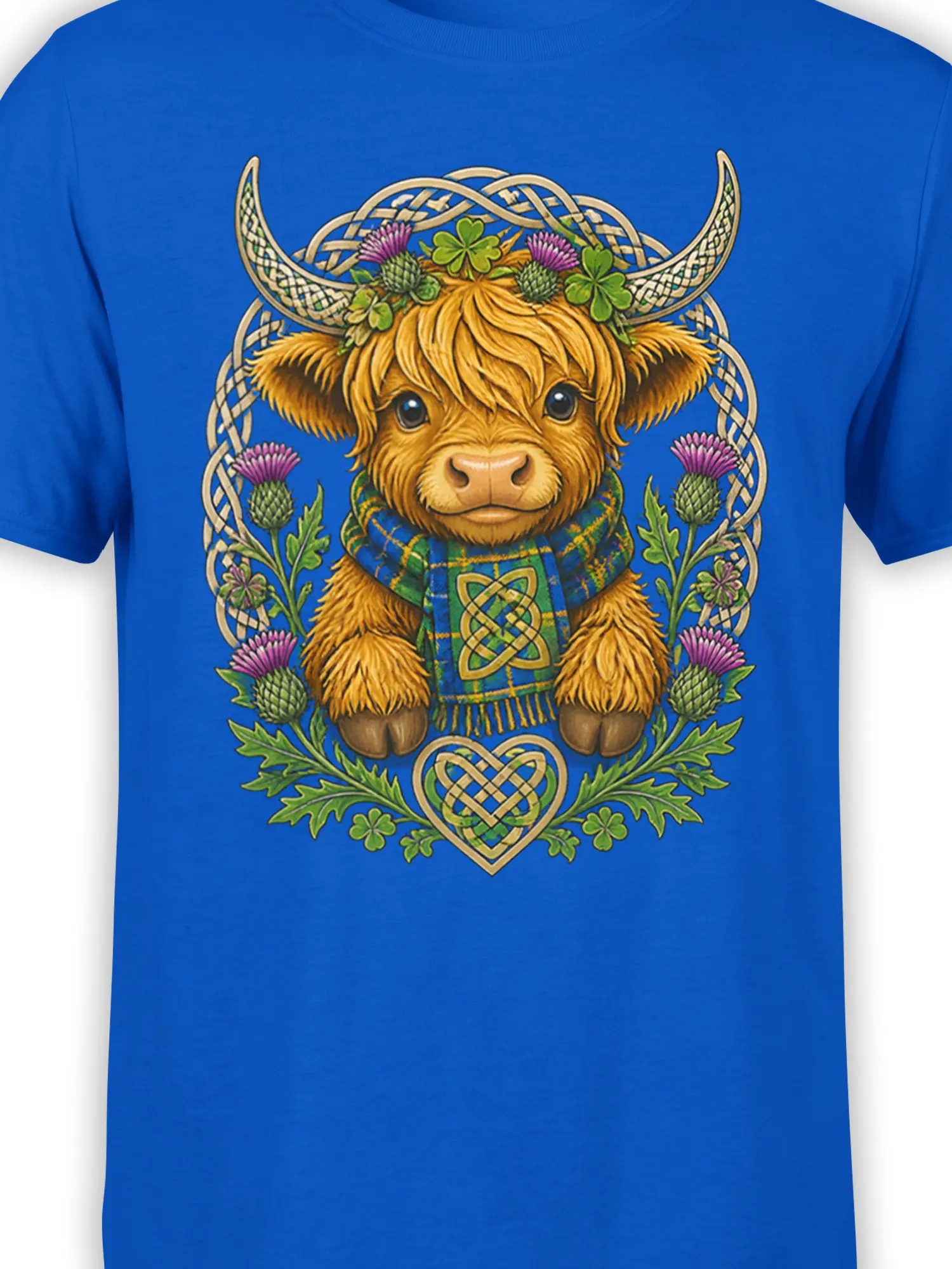 Close-up of Highland cow artwork with horns, thistles, shamrocks, knotwork, and tartan details on blue fabric