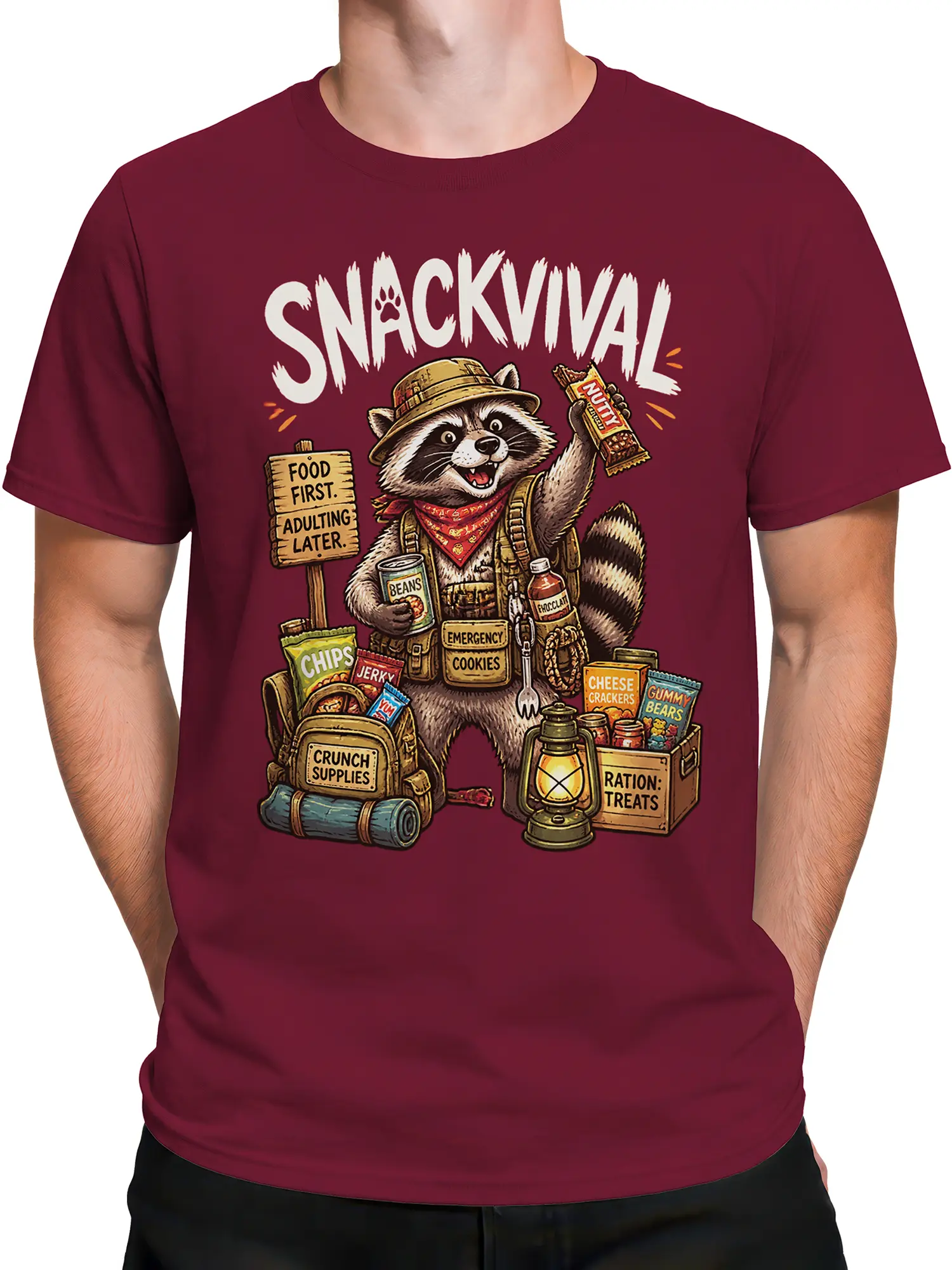 Male torso wearing a burgundy raccoon T-shirt with snack supplies, camping gear, and bold survival-themed lettering