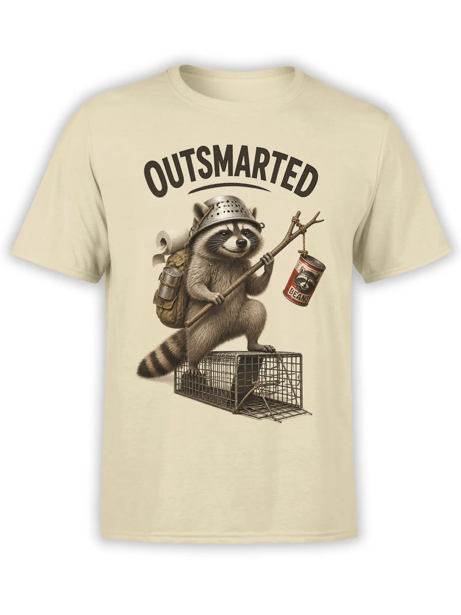 Beige T-shirt with an “OUTSMARTED” raccoon escaping an open wire trap with a backpack and bean can