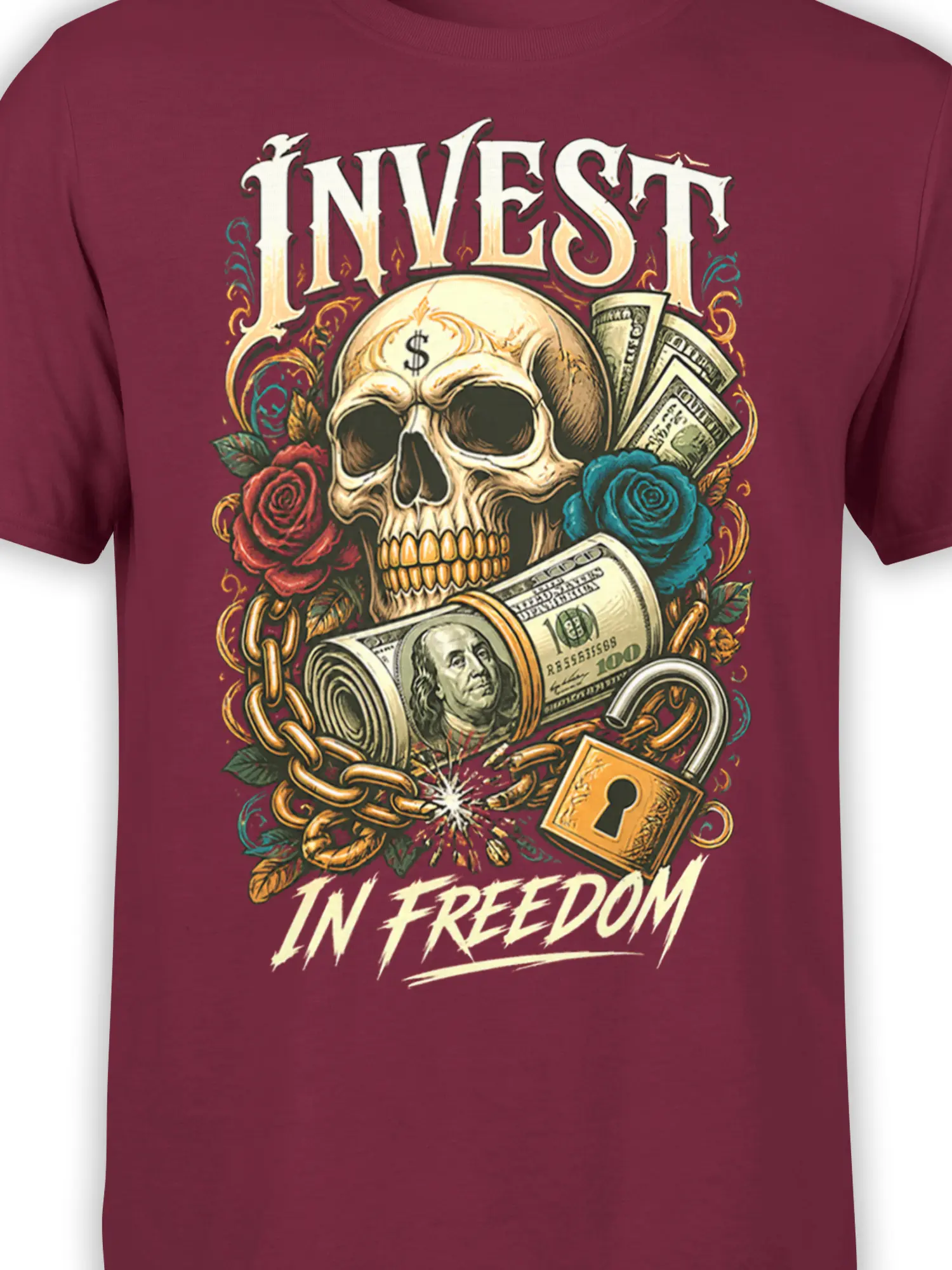 Close-up of skull, dollar bills, roses, broken chain, lock, and freedom lettering on a burgundy graphic T-shirt