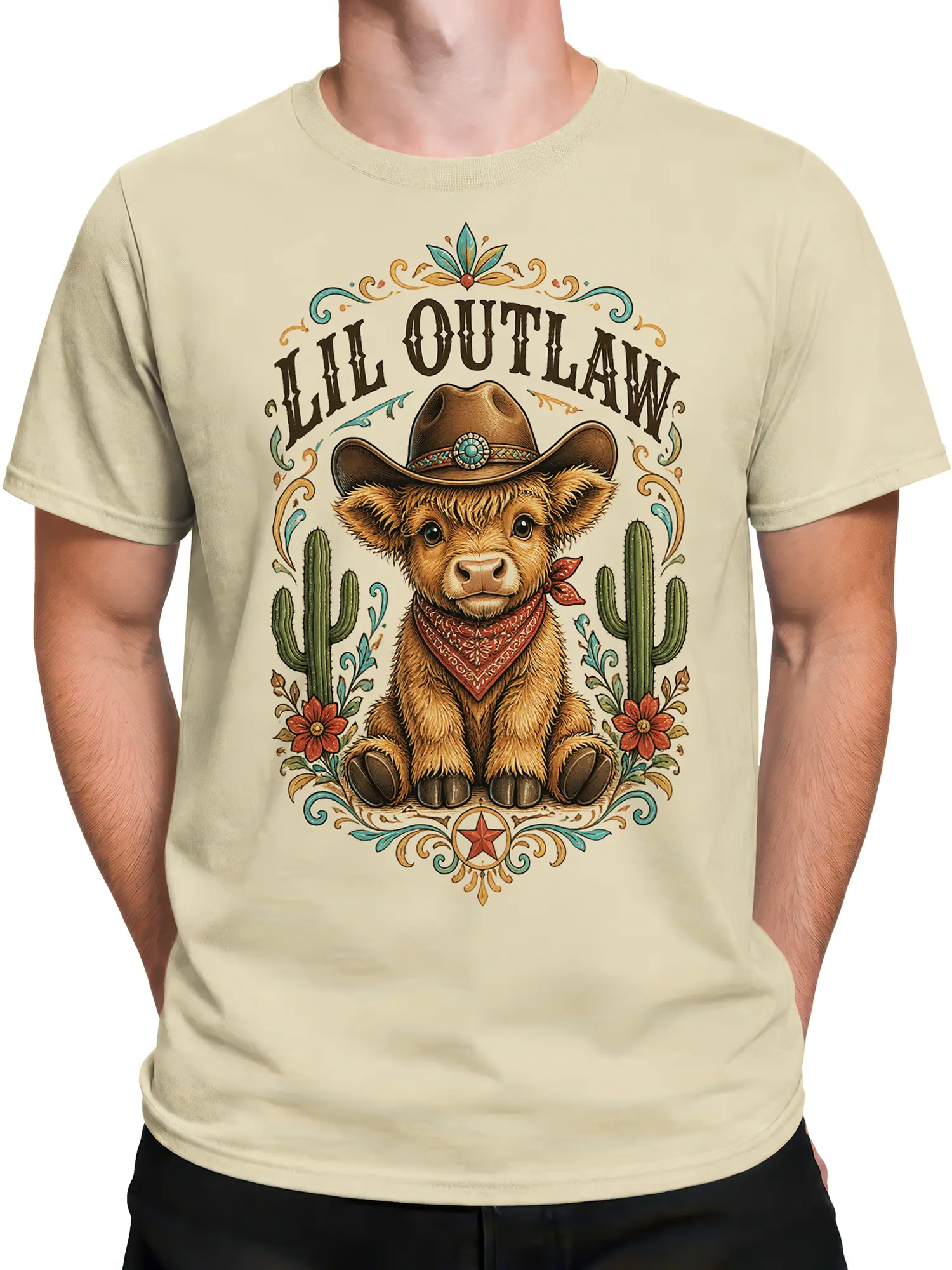 Male torso wearing a beige western T-shirt with a cowboy highland cow and ALL OUTLAW graphic