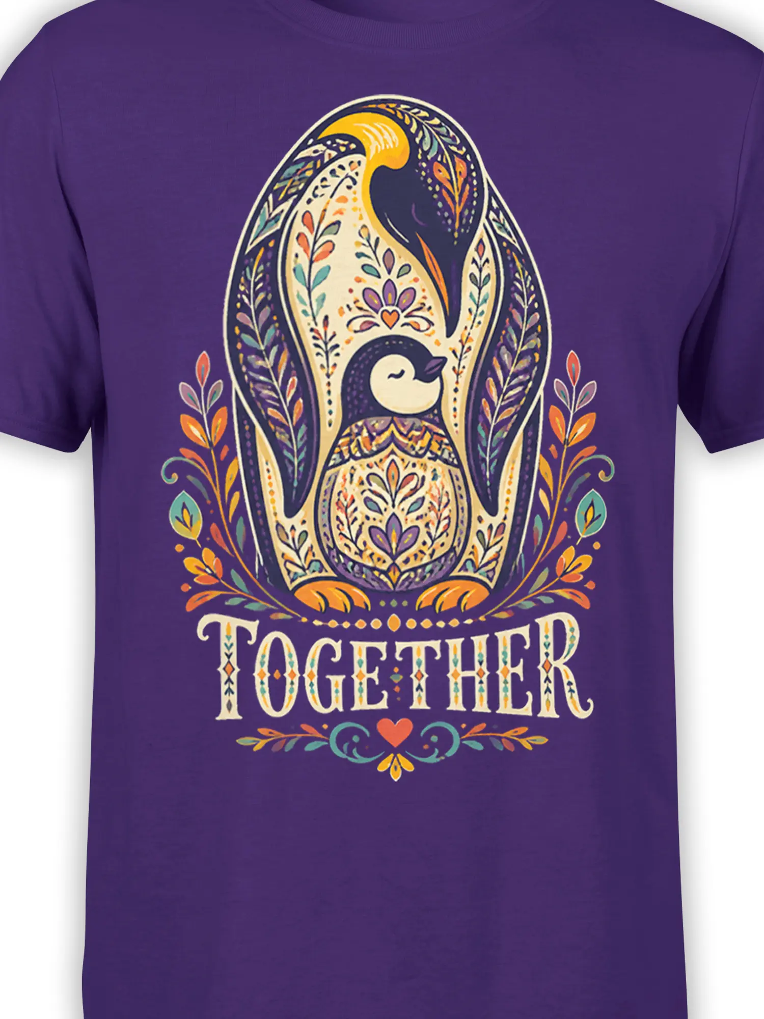 Close-up of the patterned penguin and floral folk-art design on a purple T-shirt
