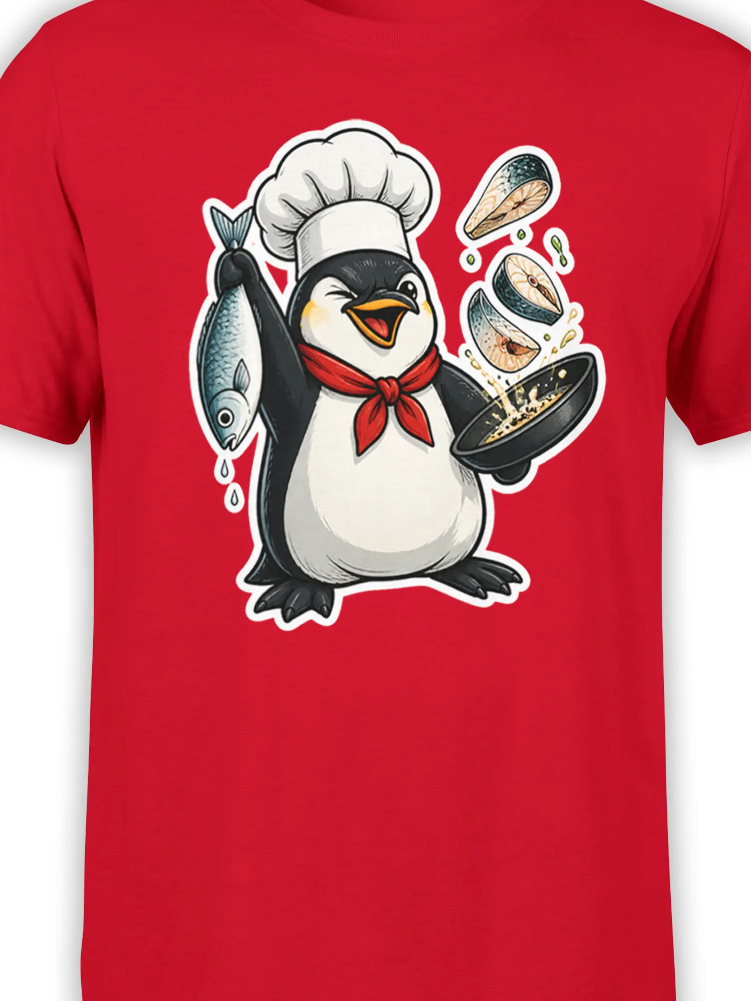 Close-up of penguin chef artwork with fish and cooking pan on a red T-shirt