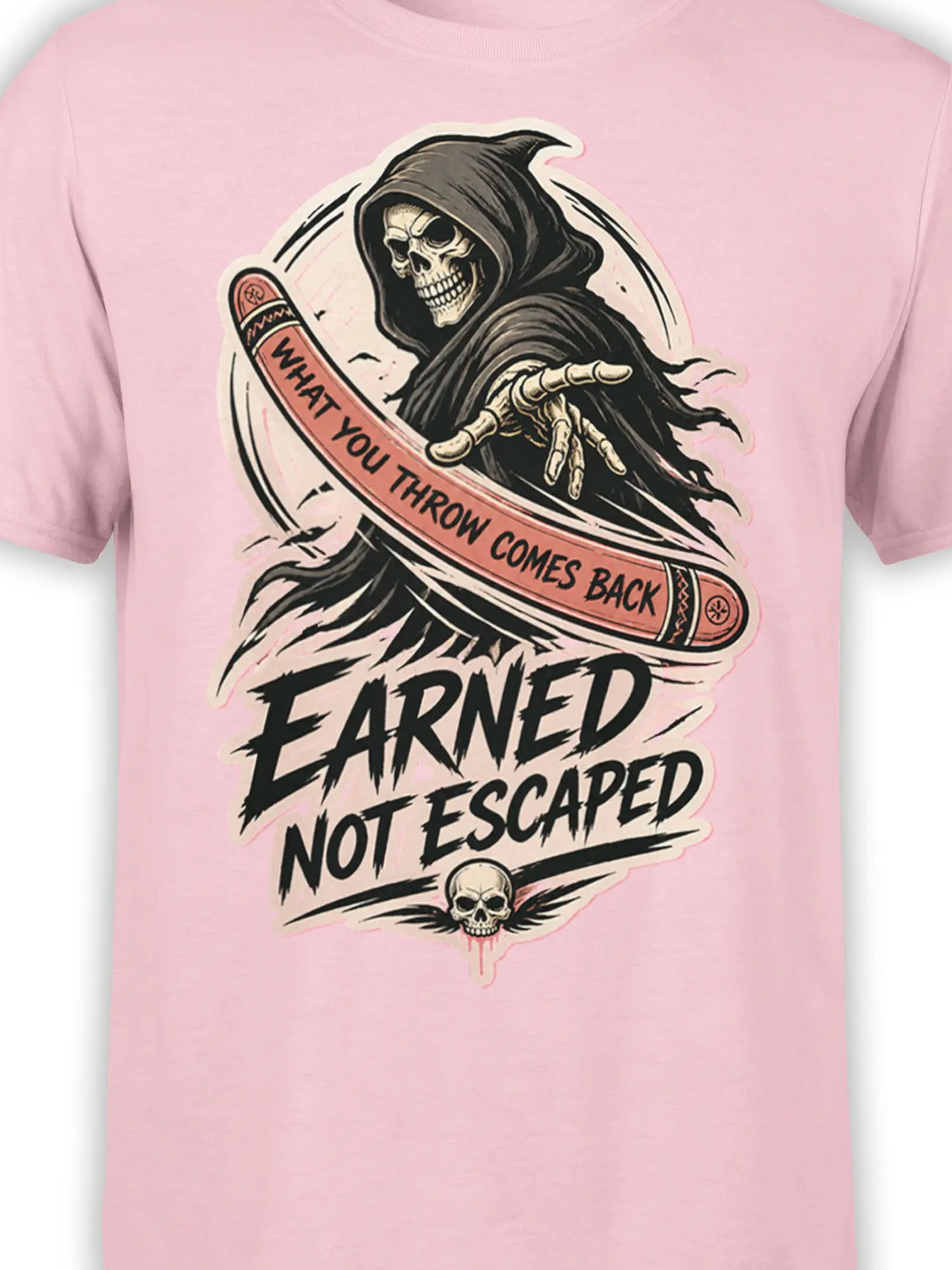 Close-up of hooded reaper skull and “What You Throw Comes Back” artwork on pink T-shirt