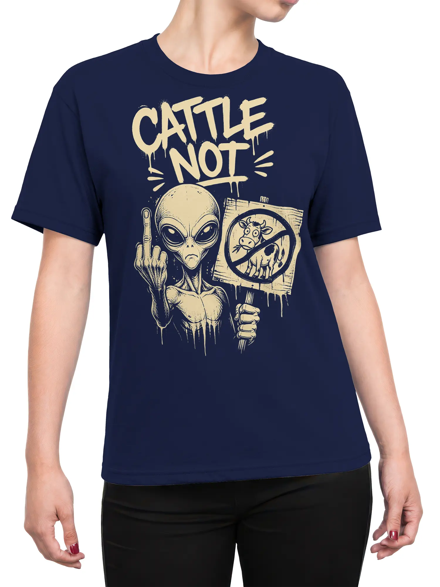 Female torso wearing a navy alien T-shirt with cream “CATTLE NOT” protest artwork and cow sign