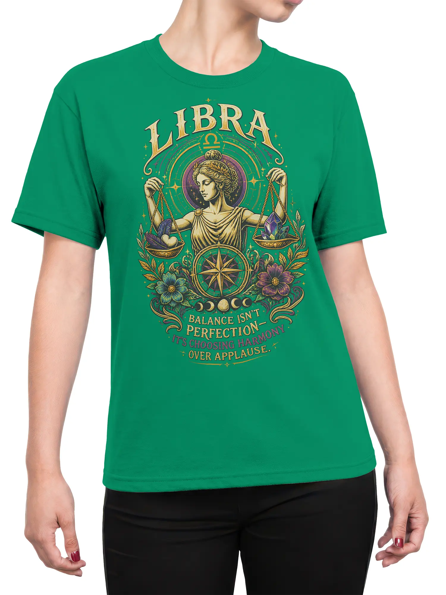 Female torso wearing a green Libra astrology T-shirt with scales, crystals, flowers, and harmony artwork