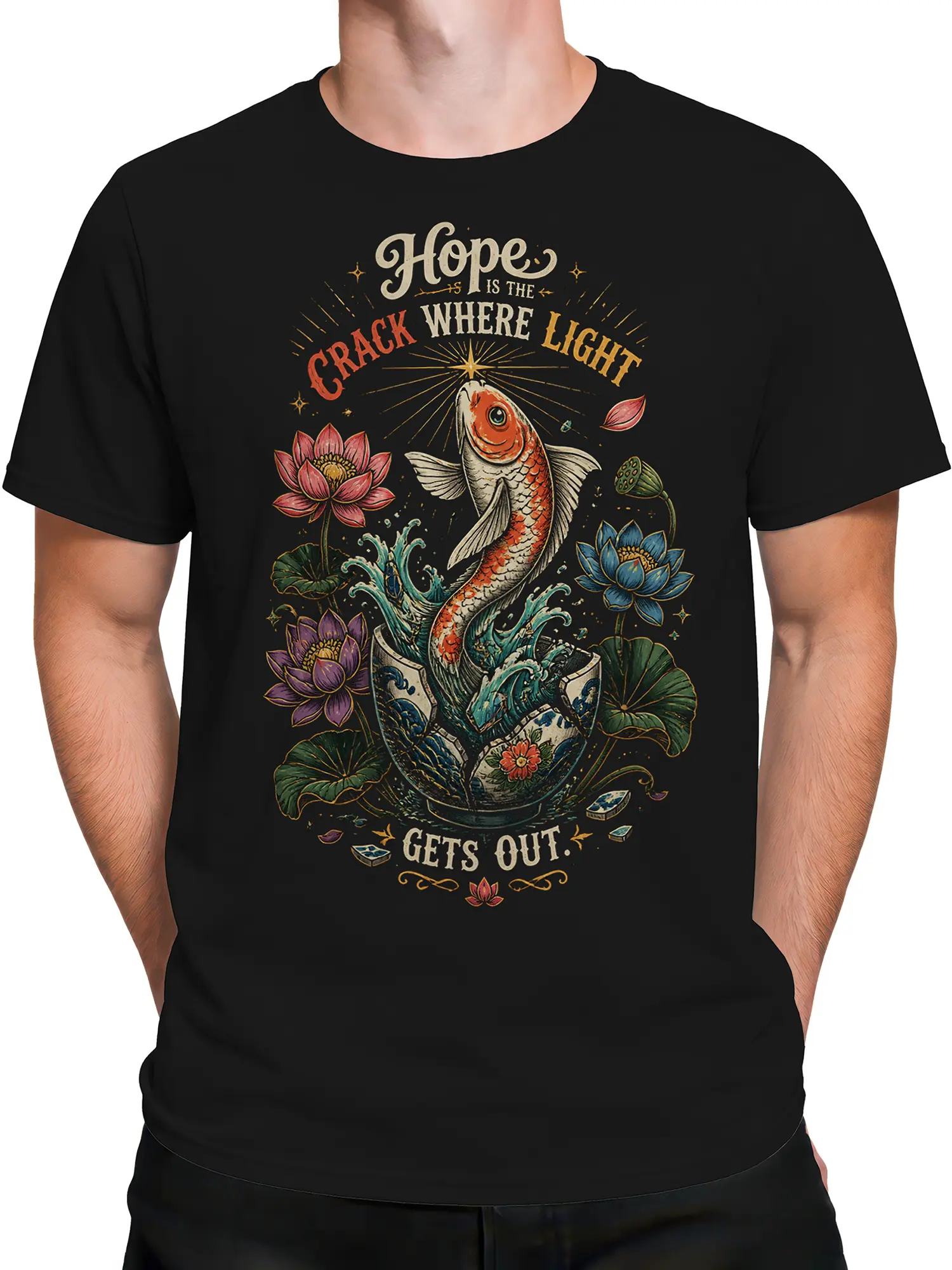 Male torso wearing a black fish graphic T-shirt with colorful koi, lotus flowers, and a vintage inspirational design