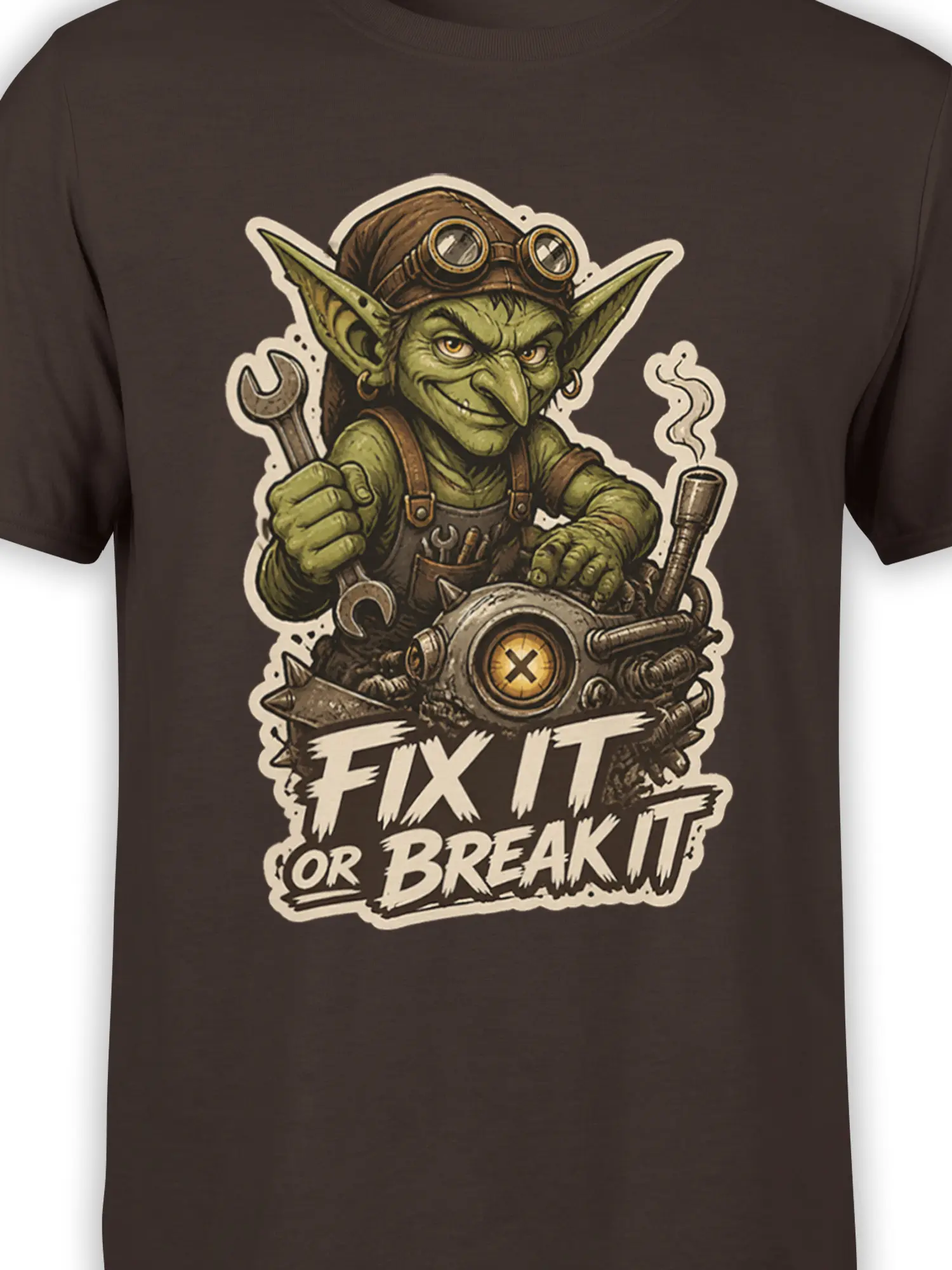Close-up of green goblin mechanic artwork, tools, machine, and bold slogan on a dark brown T-shirt
