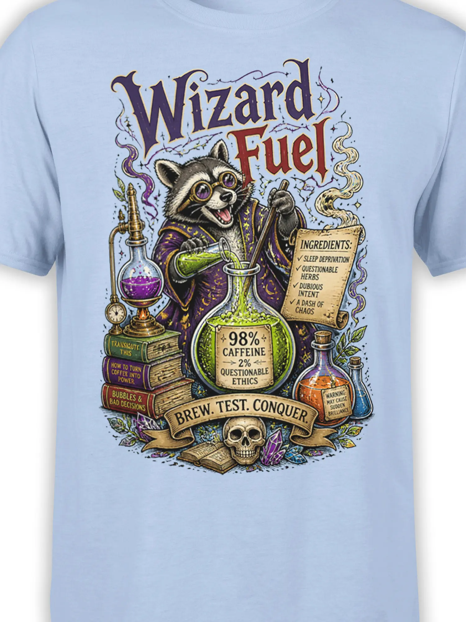 Close-up of the raccoon wizard potion artwork and caffeine humor printed on a light blue T-shirt