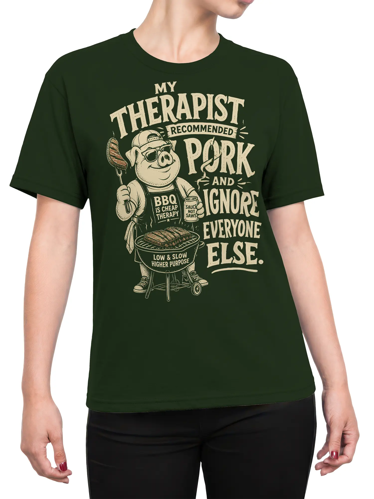 Female torso wearing a green pig barbecue T-shirt with vintage grill artwork and humorous cream lettering