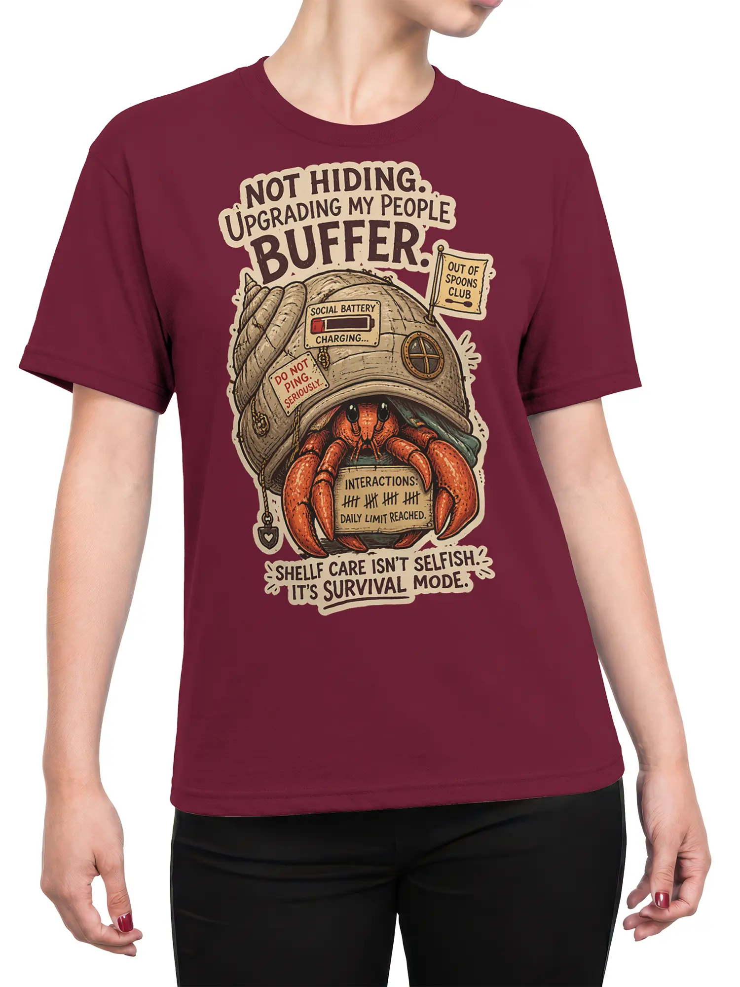 Female torso wearing a burgundy hermit crab T-shirt with introvert survival humor