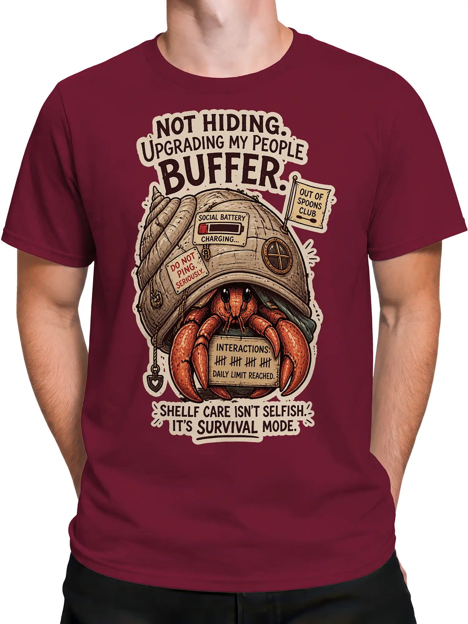 Male torso wearing a burgundy hermit crab graphic tee with social battery humor