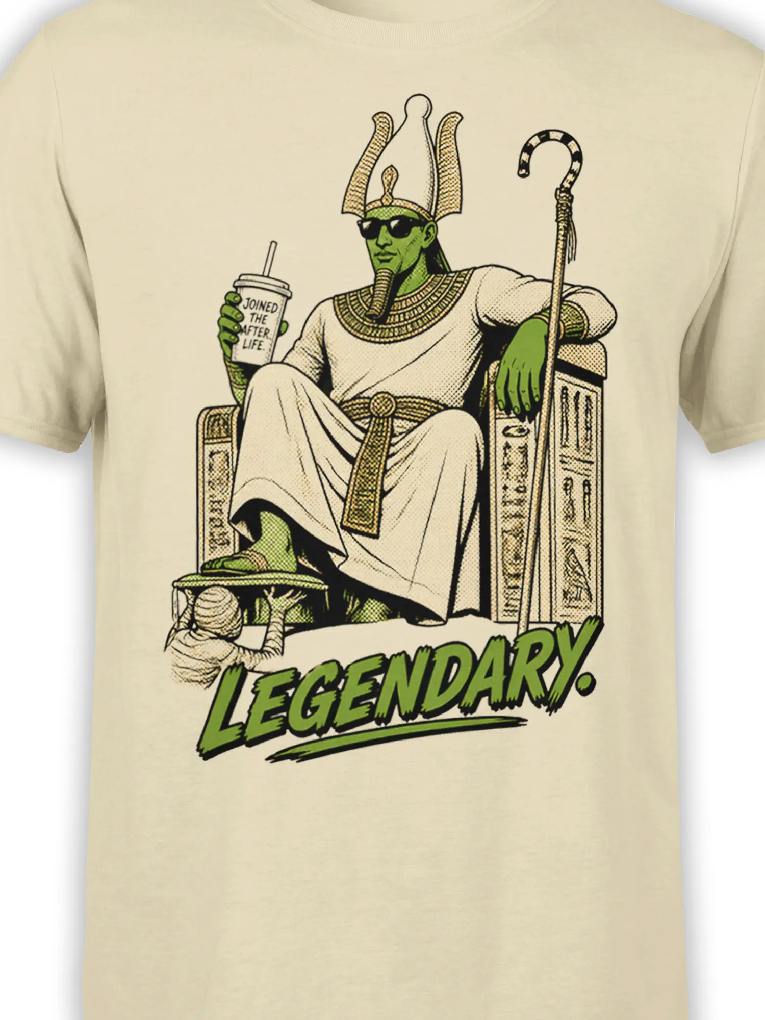 Close-up of the beige shirt design showing a green pharaoh in sunglasses, ceremonial robes, throne, and “LEGENDARY.” text