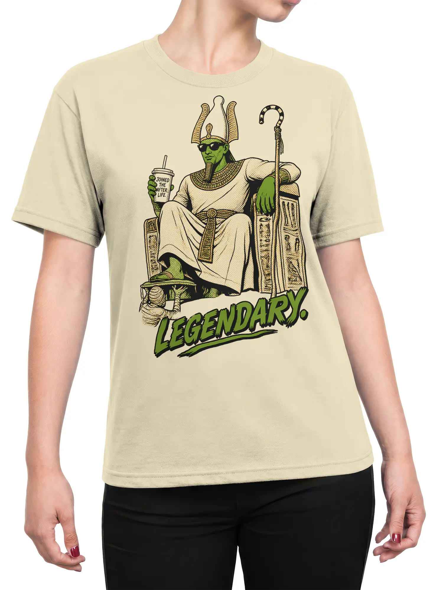 Female torso wearing a beige Egyptian-inspired pharaoh T-shirt with green ruler and “LEGENDARY.” graphic