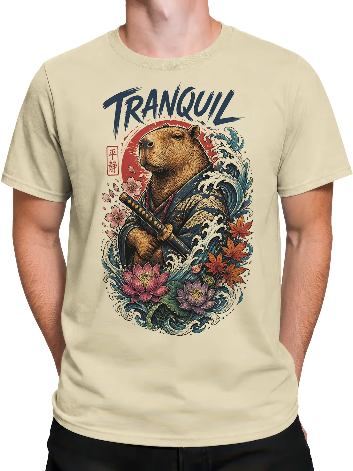Male torso wearing a beige capybara warrior T-shirt with blue waves, flowers, maple leaves, and a katana