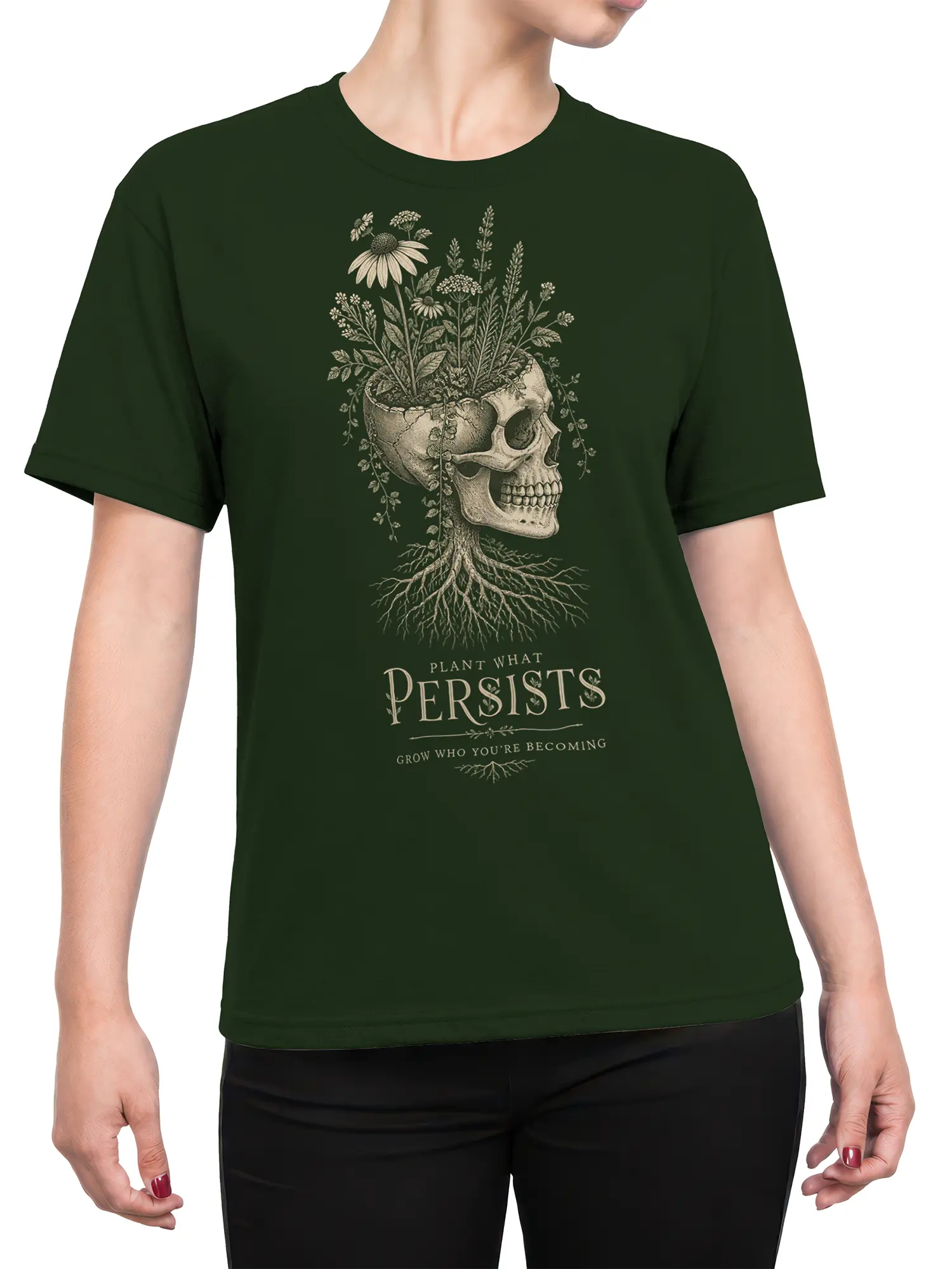 Female torso wearing a green botanical skull T-shirt with flowers, roots, and a growth message