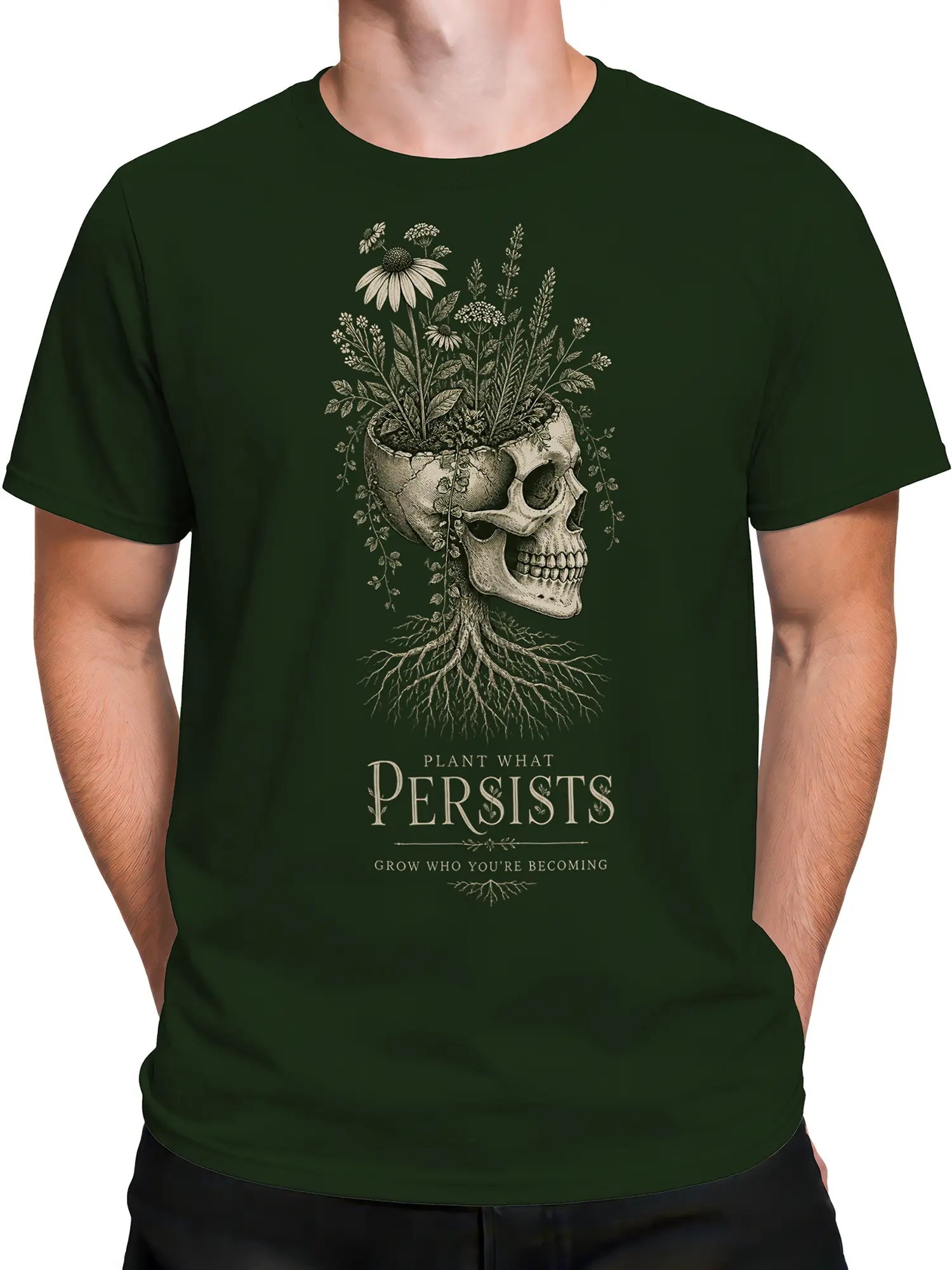 Male torso wearing a green botanical skull T-shirt with flowers, roots, and inspirational text