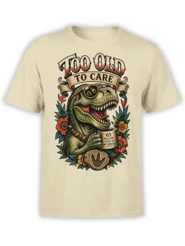 Beige T-shirt with a vintage green T. rex, eyepatch, coffee mug, flowers, and “Too Old to Care” artwork