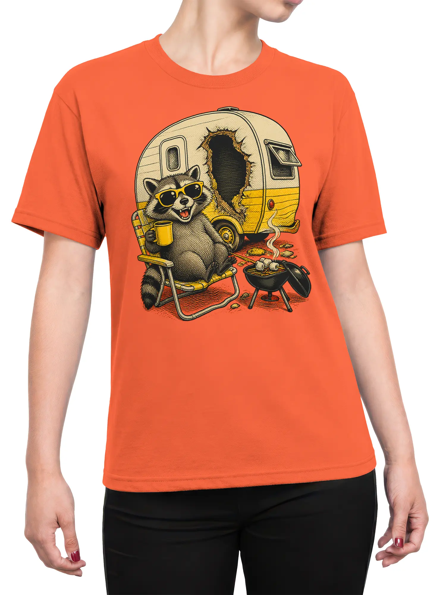 Female torso wearing an orange raccoon camping T-shirt with a camper, coffee mug, chair, and grill graphic