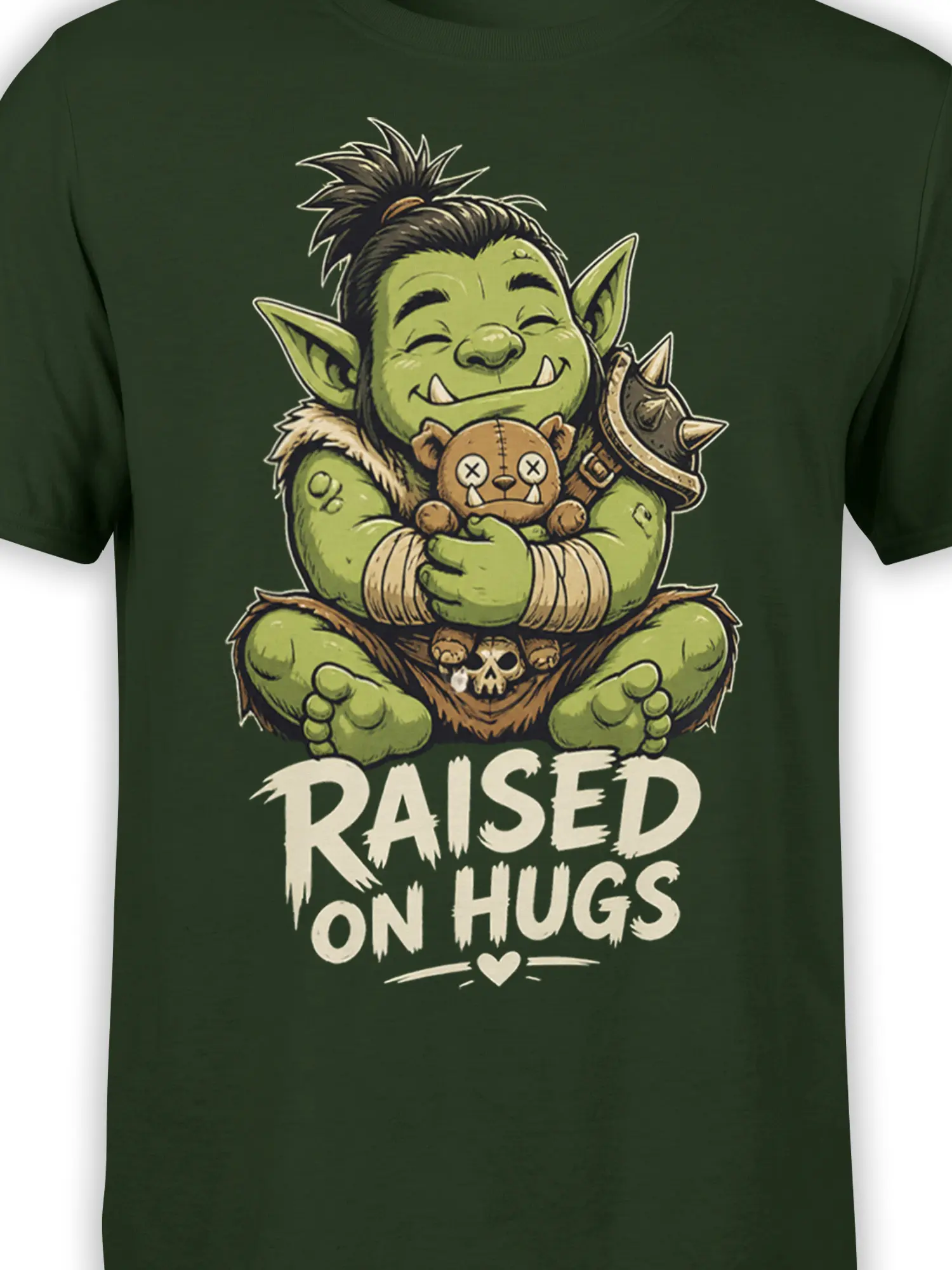 Close-up of the green goblin, teddy bear, spiked armor, and “RAISED ON HUGS” design on dark green fabric