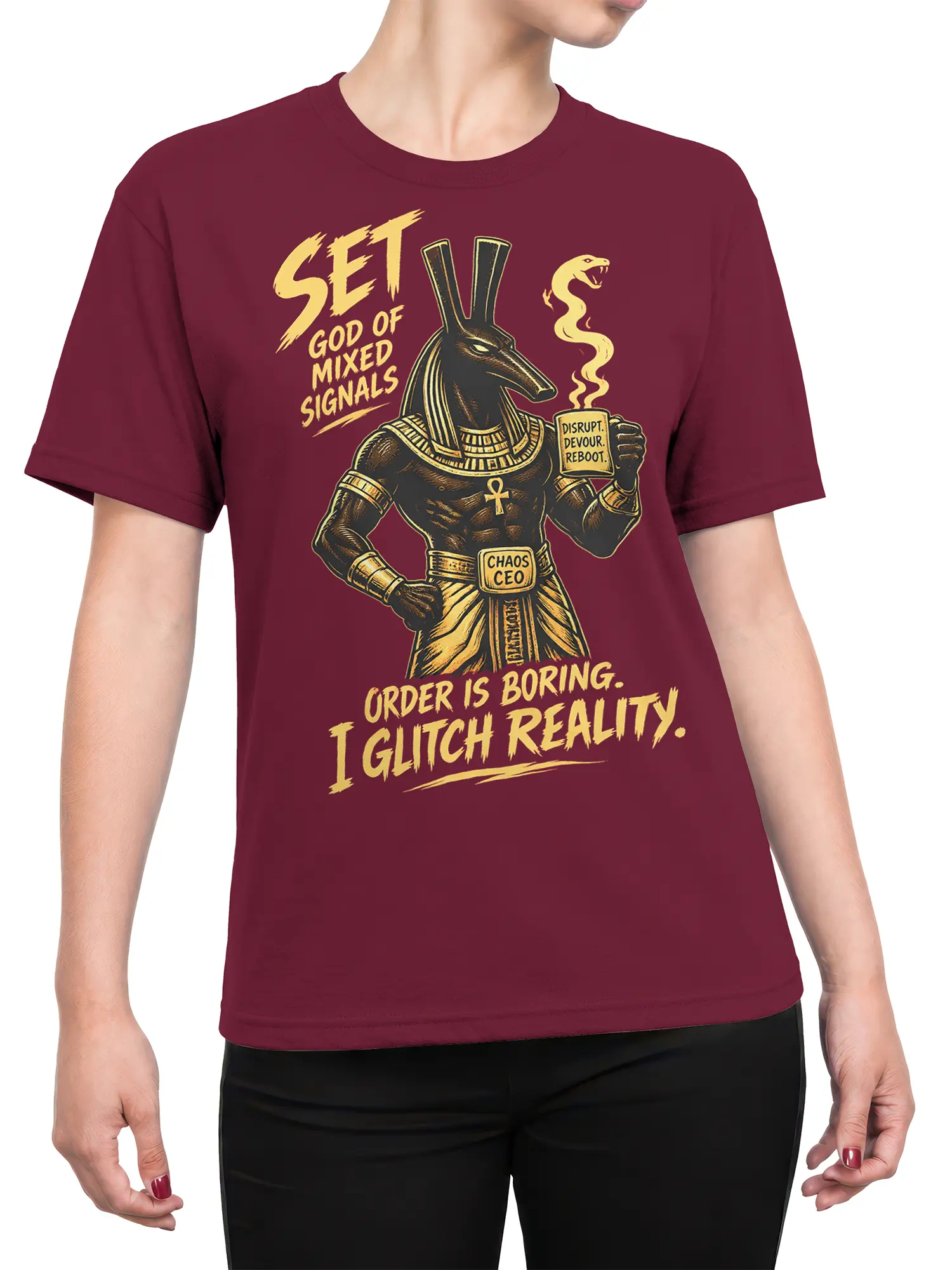 Female torso wearing a burgundy T-shirt with Egyptian jackal deity artwork and chaos-themed text