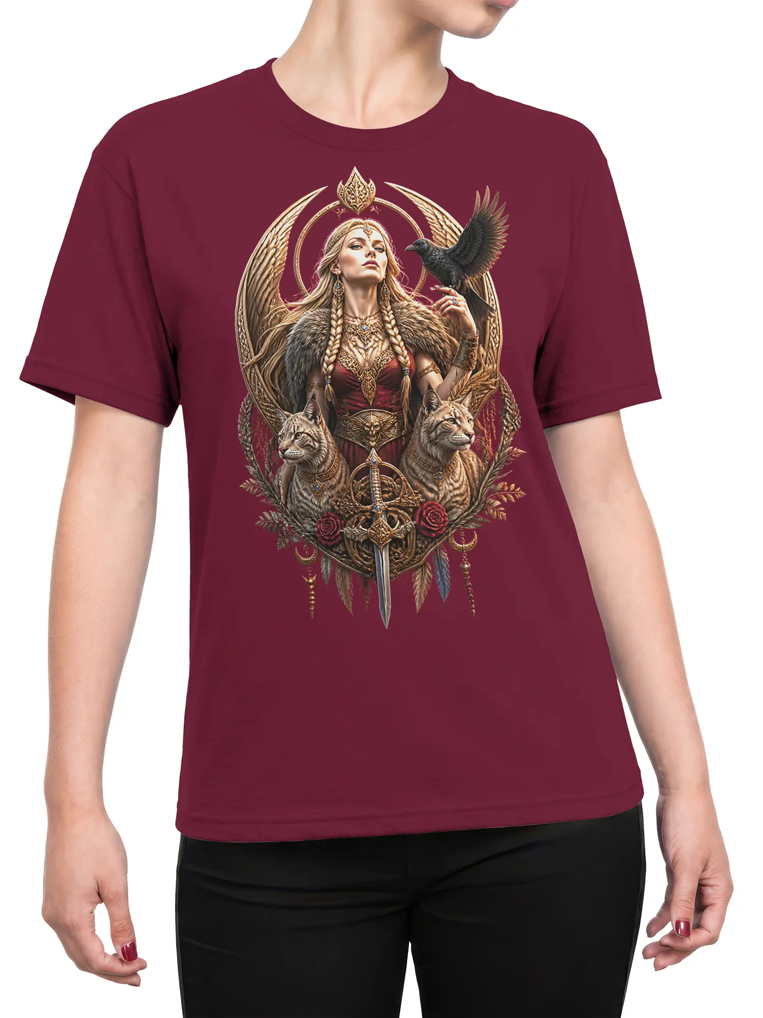Female torso wearing a burgundy T-shirt with winged guardian, raven, feline, and sword graphic artwork