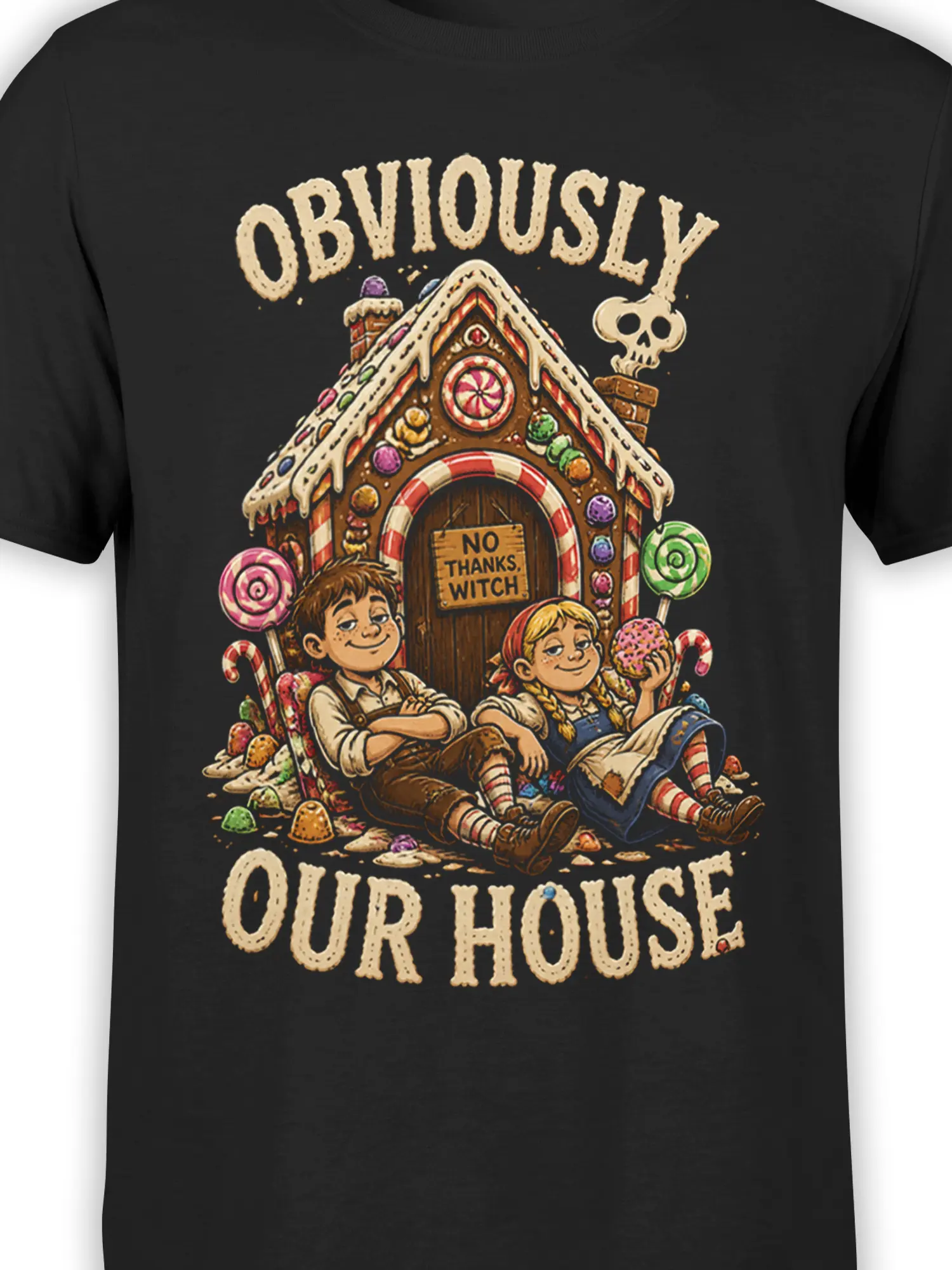 Close-up of the candy house graphic, children, sweets, and “No Thanks, Witch” sign on a black T-shirt