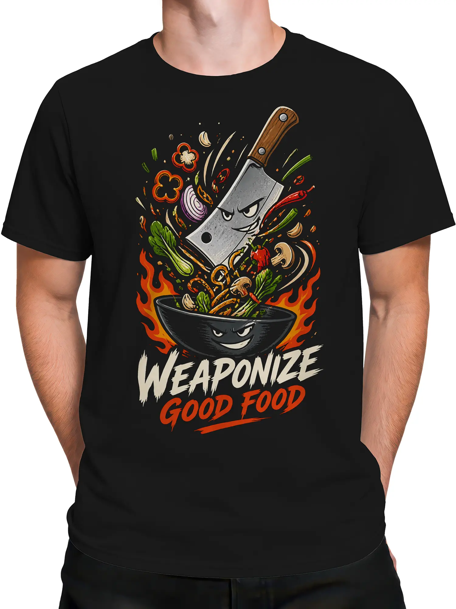Male torso wearing a black T-shirt with a fierce cleaver, grinning bowl, flames, vegetables, and bold kitchen artwork