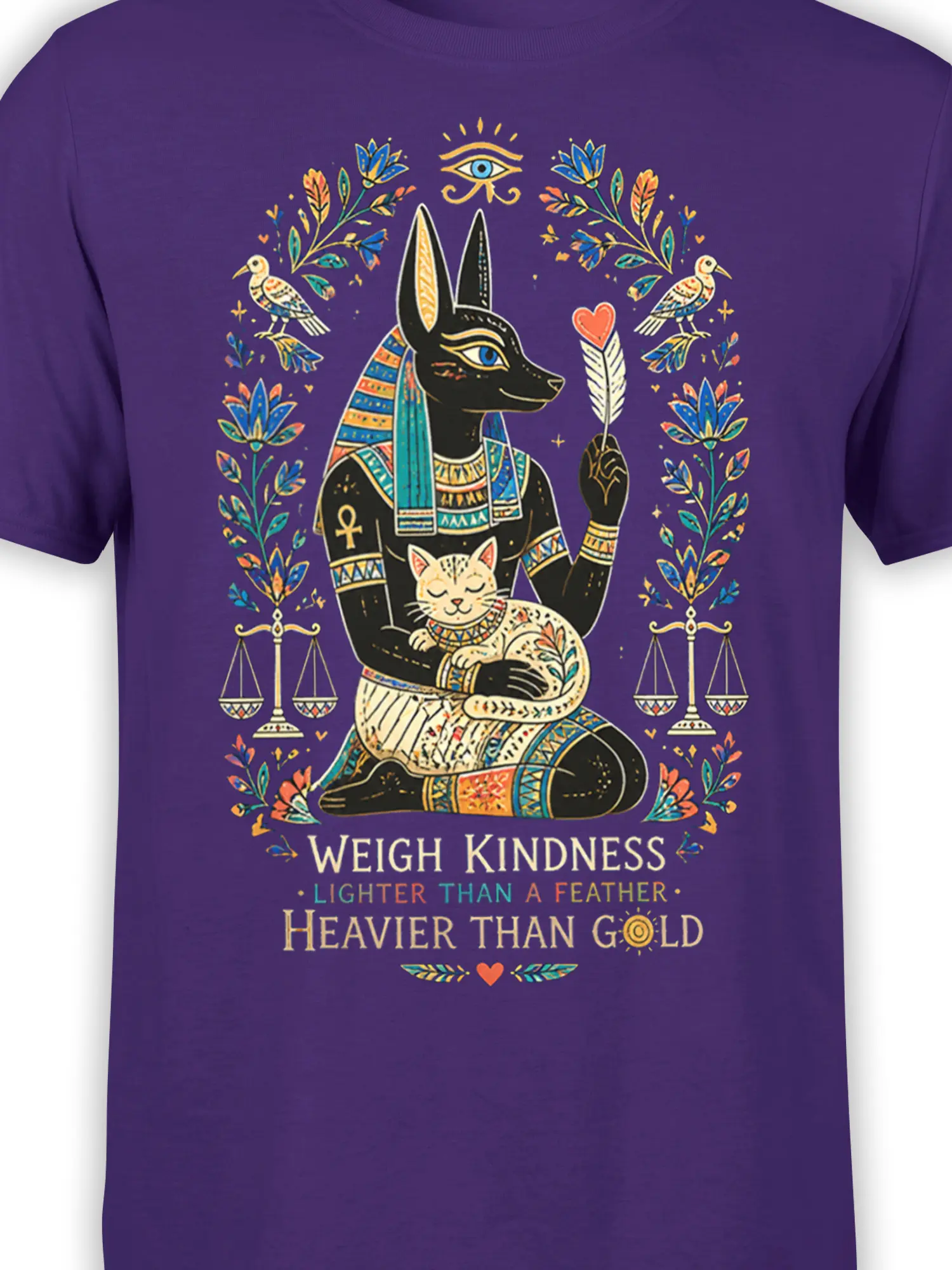 Close-up of Egyptian-inspired jackal figure and sleeping cat artwork on a purple graphic T-shirt