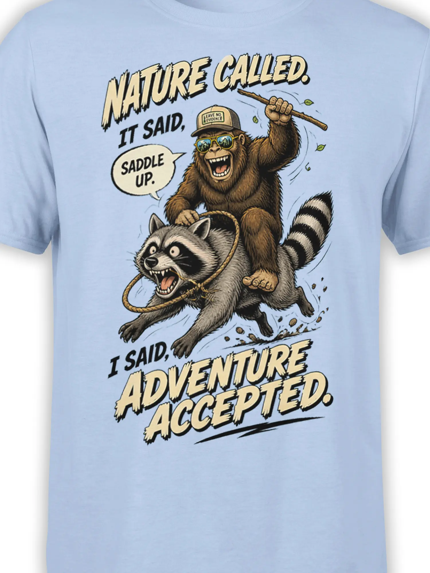 Close-up of monkey riding a raccoon on a light blue shirt with vintage comic-style lettering