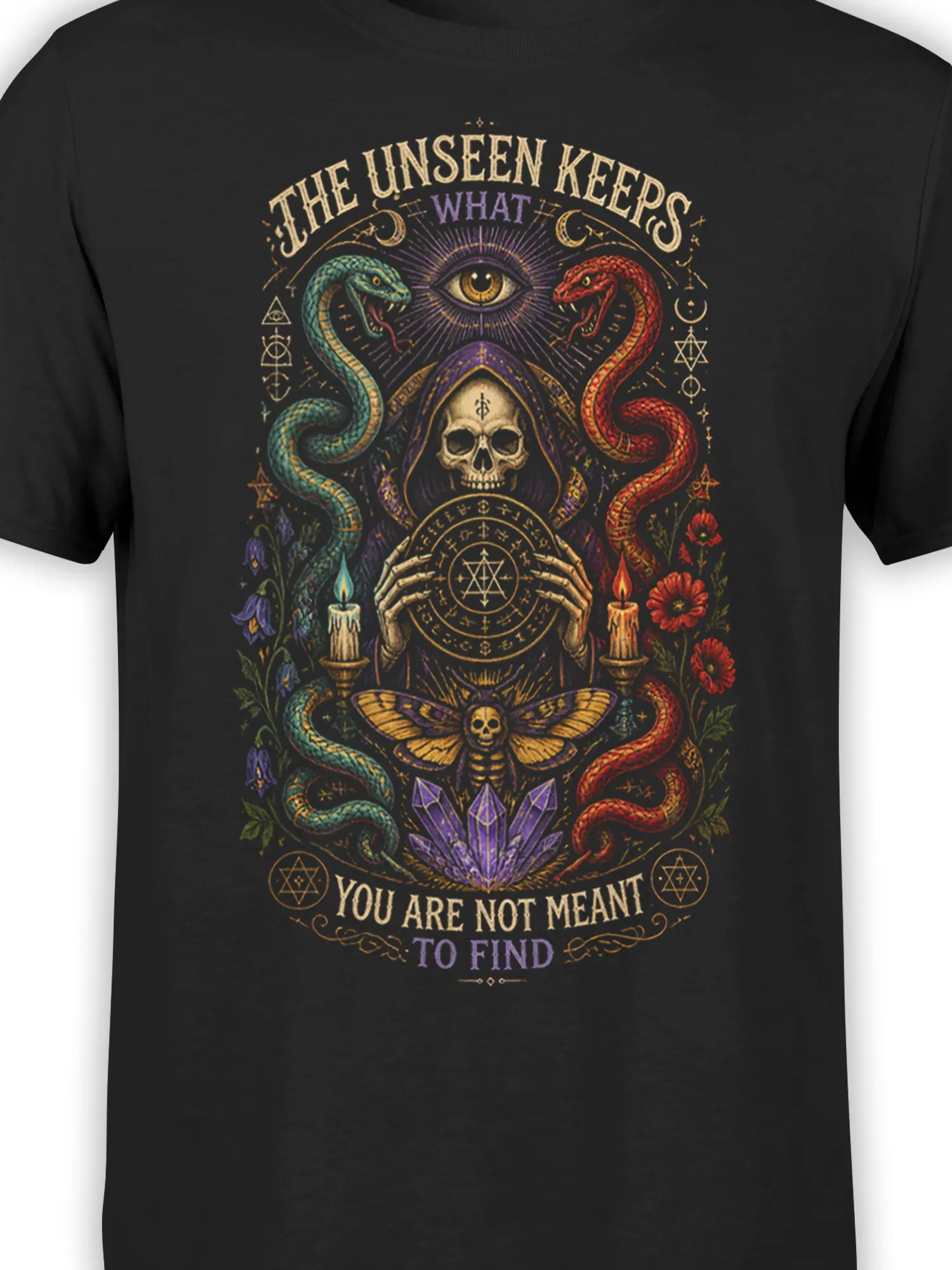 Close-up of black occult T-shirt artwork with twin snakes, skull, eye, crystals, candles, and vintage lettering