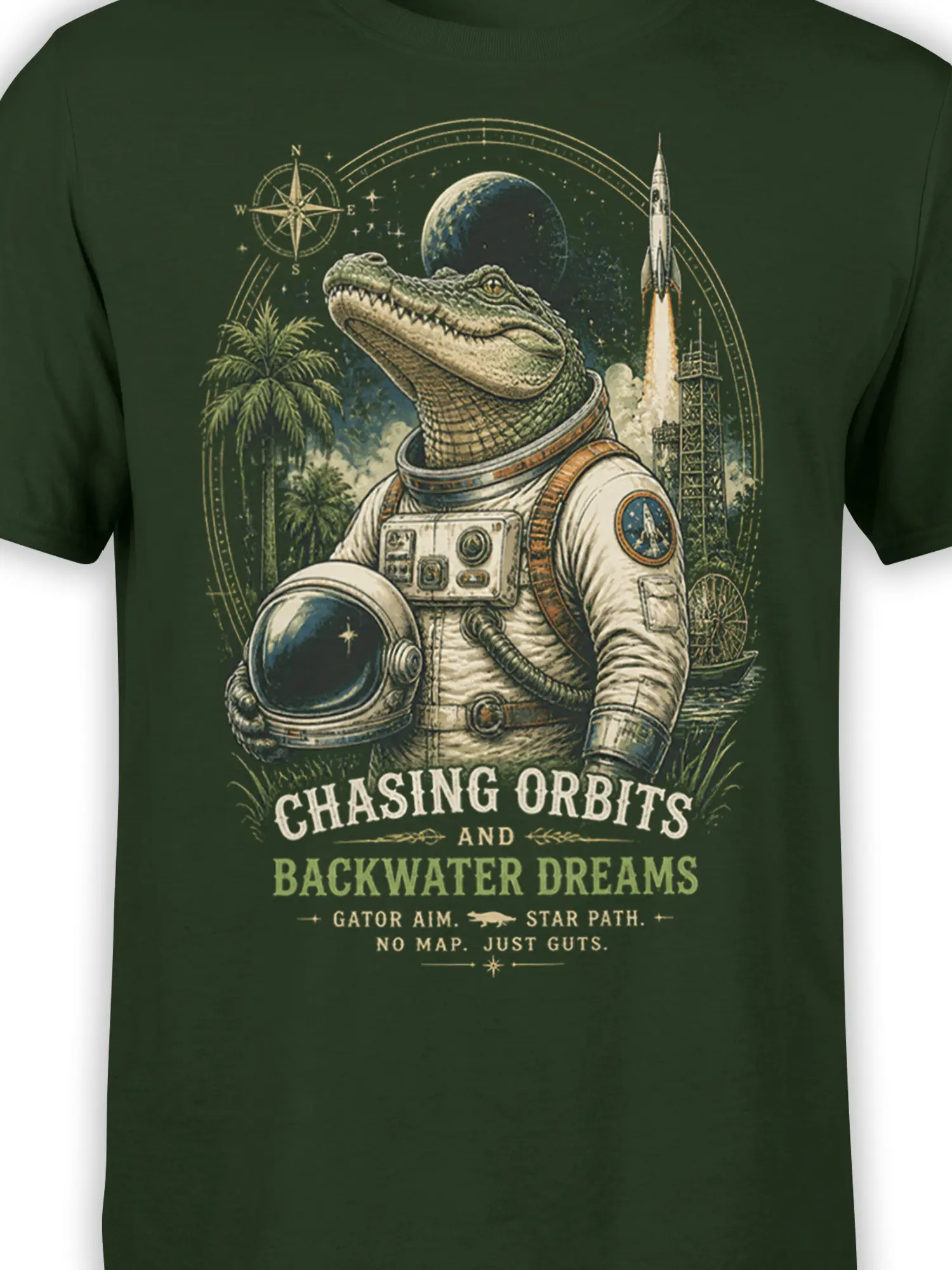 Close-up of green T-shirt graphic showing an alligator astronaut, rocket, planet, stars, and retro orbit artwork