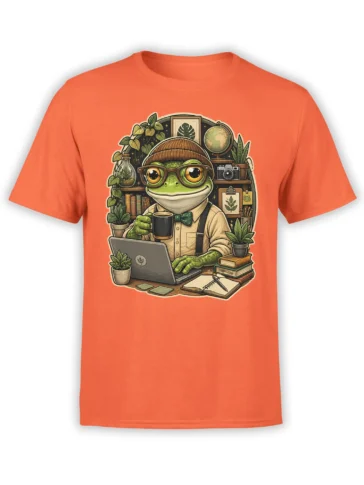 Green frog in glasses and beanie works on a laptop with coffee on an orange T-shirt