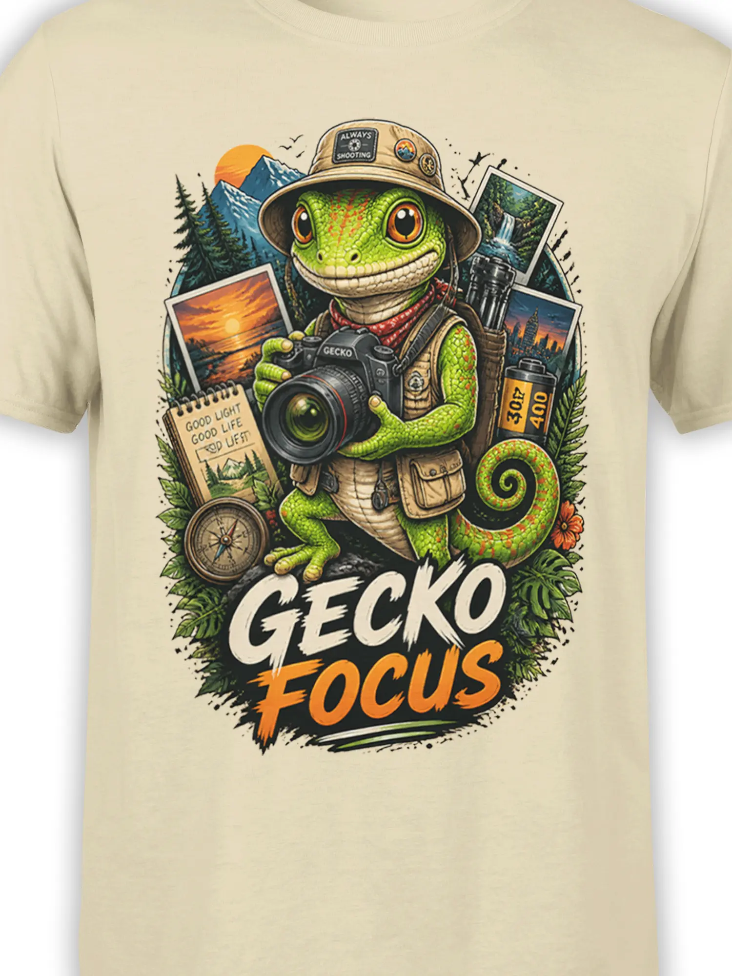 Close-up of green gecko photographer artwork, camera, mountain scenery, and GECKO FOCUS lettering on beige fabric
