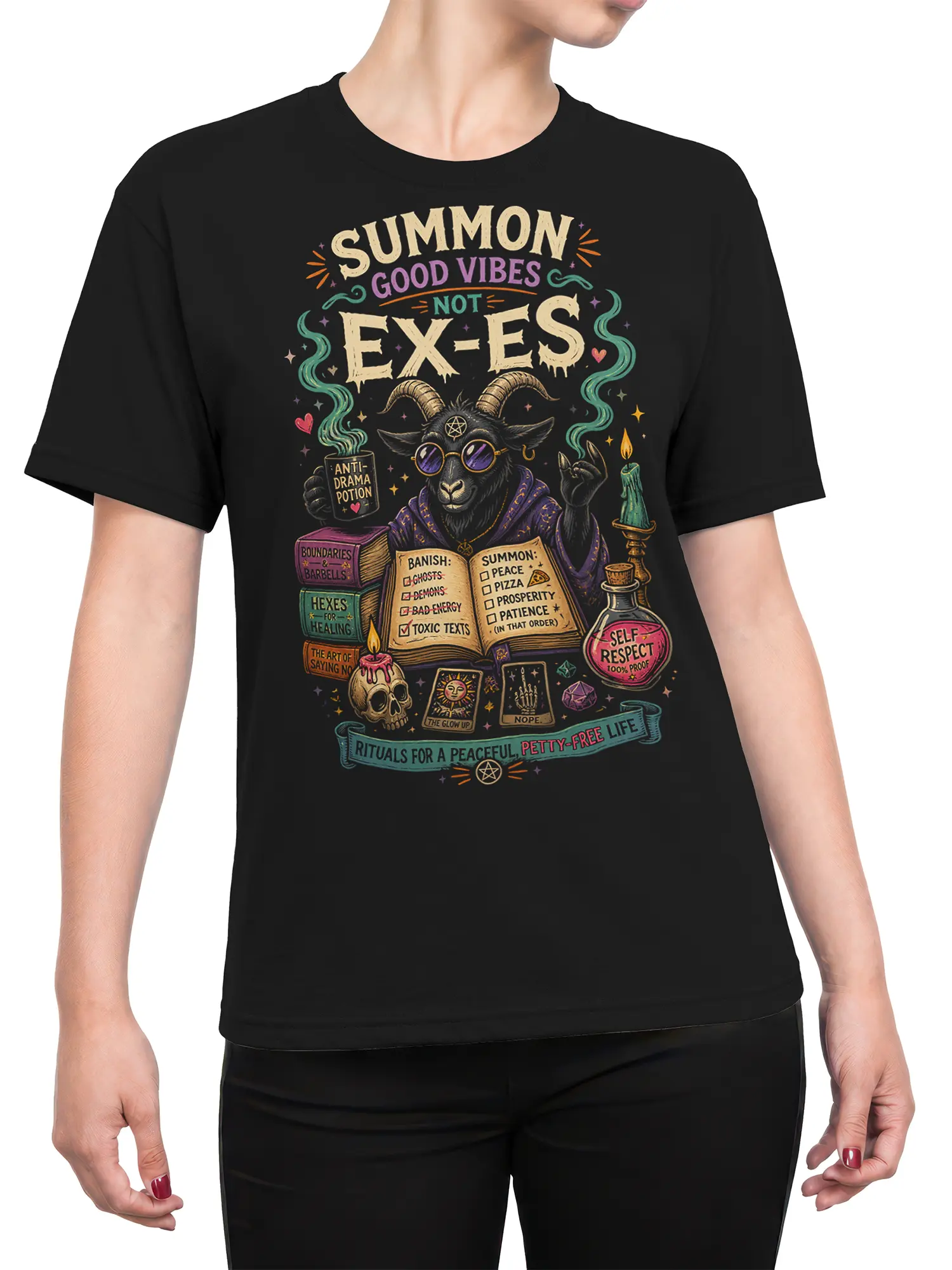 Female torso wearing a black T-shirt with a horned goat and colorful anti-drama occult artwork