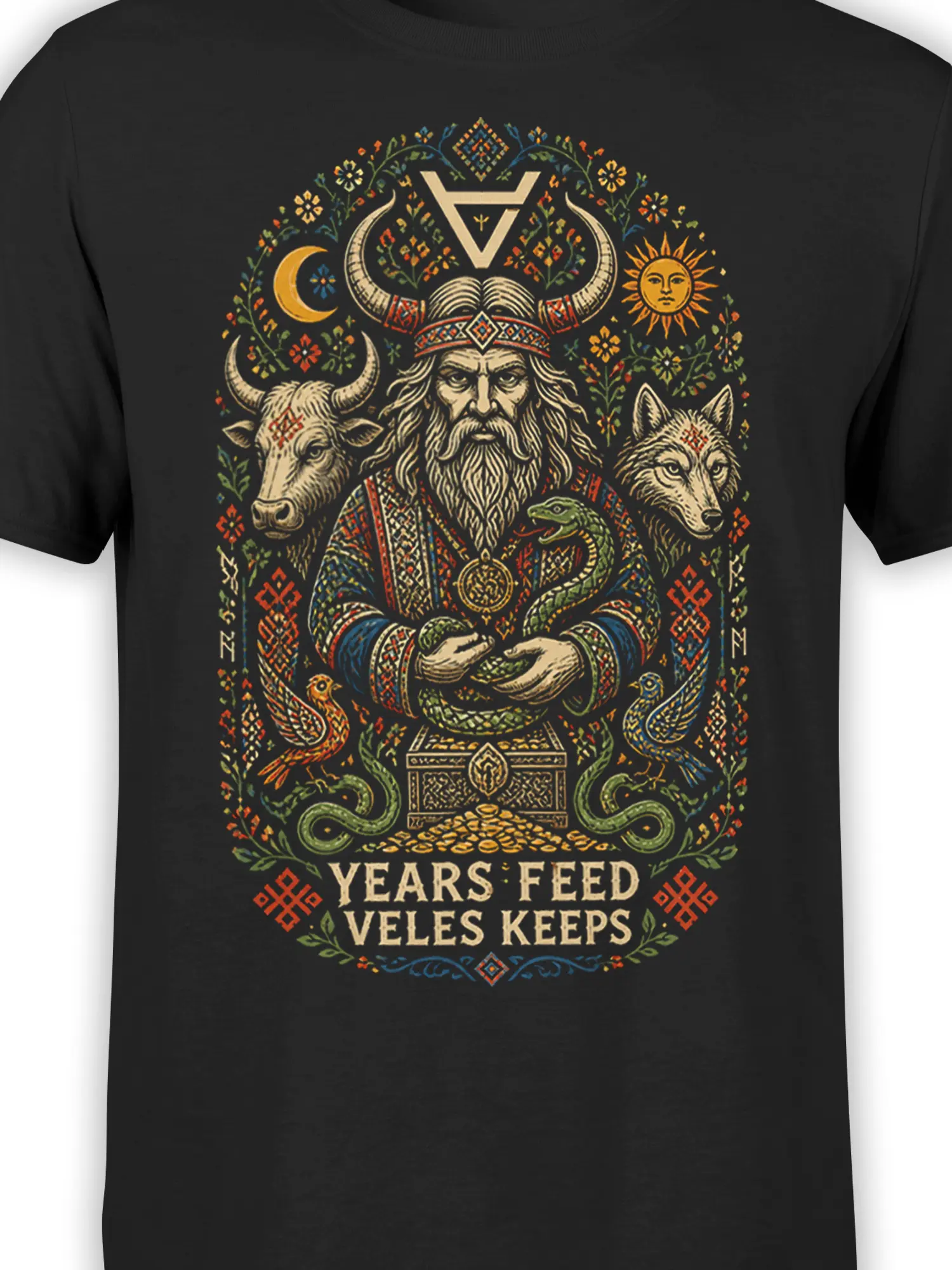 Close-up of black mythology shirt design with horned figure, wolf, bull, snakes, and colorful folk details