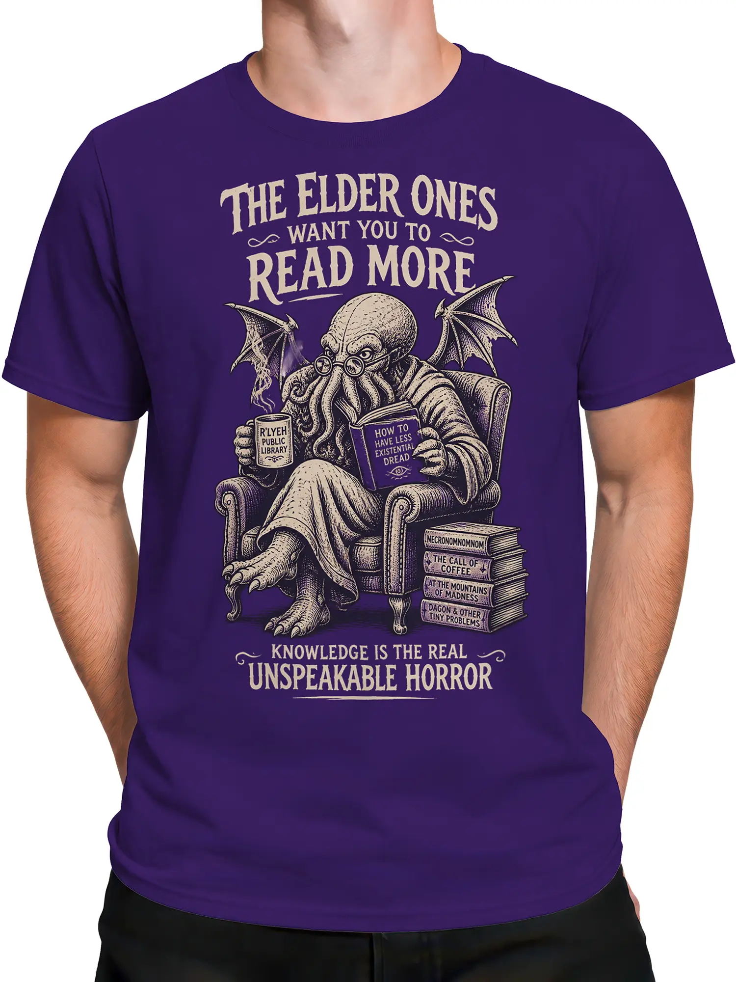 Male torso wearing a purple cosmic horror octopus tee with a book, coffee mug, and vintage cream design