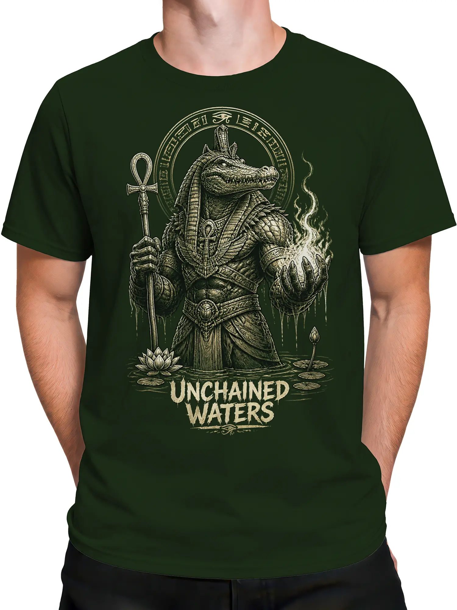 Male torso wearing a green crocodile deity T-shirt with symbolic water artwork and cream lettering