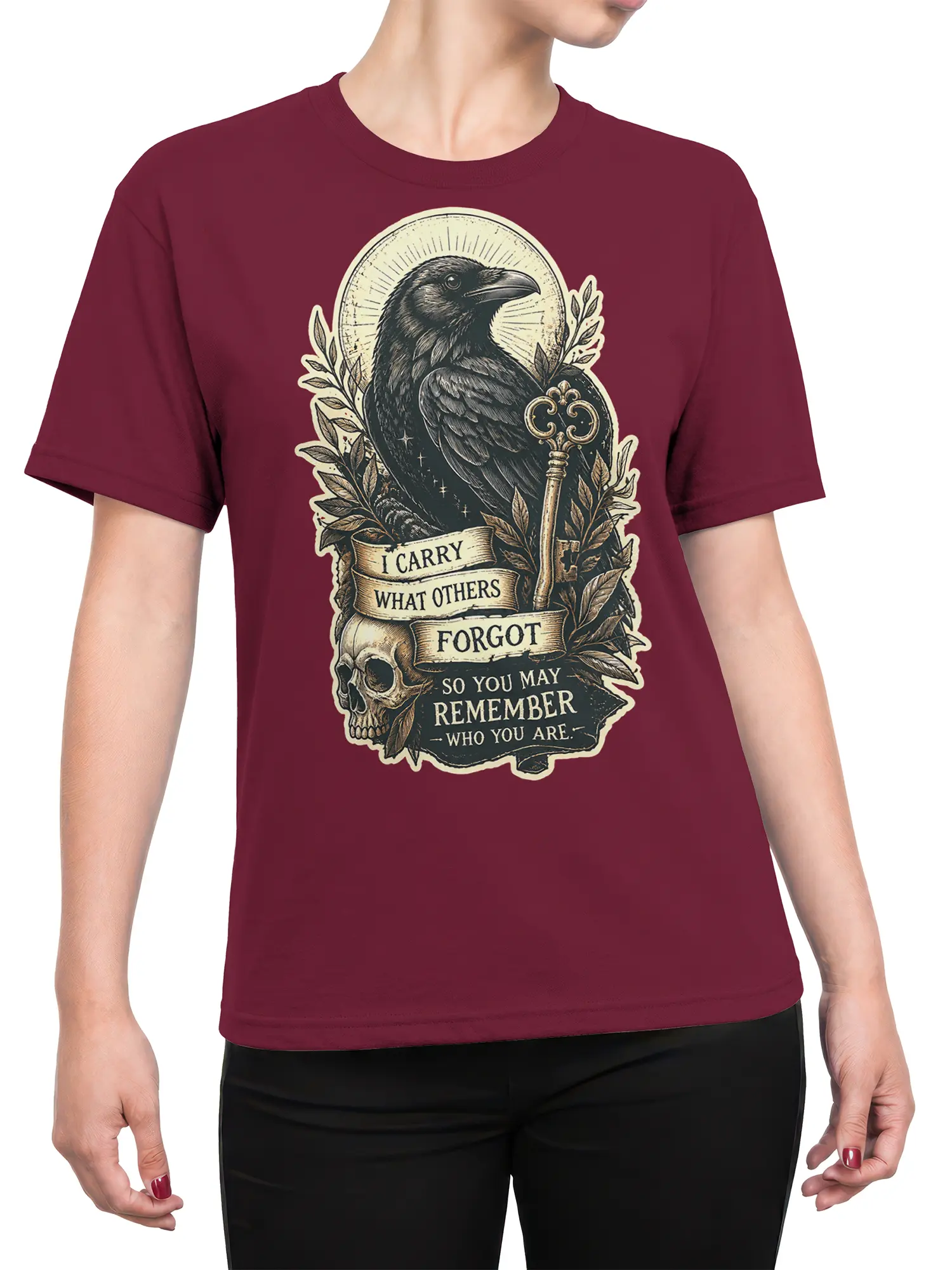 Female torso wearing burgundy T-shirt with vintage raven, skull, ornate key, and memory banner